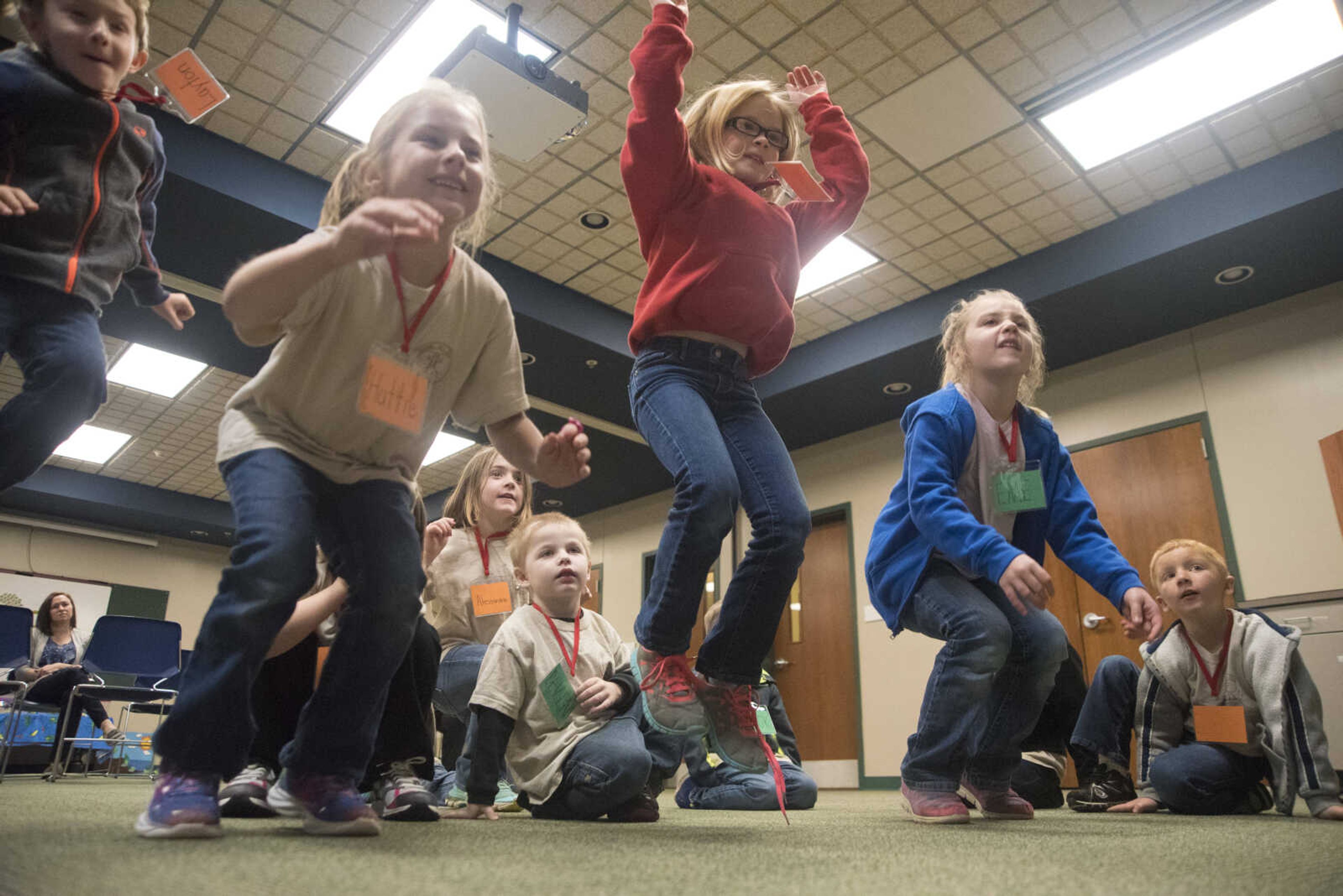 Students jump when asked by Jordi Brostoski while learning about a frog's life cycle at the Cape Girardeau Conservation Nature Center Wednesday, March 29, 2017 in Cape Girardeau.