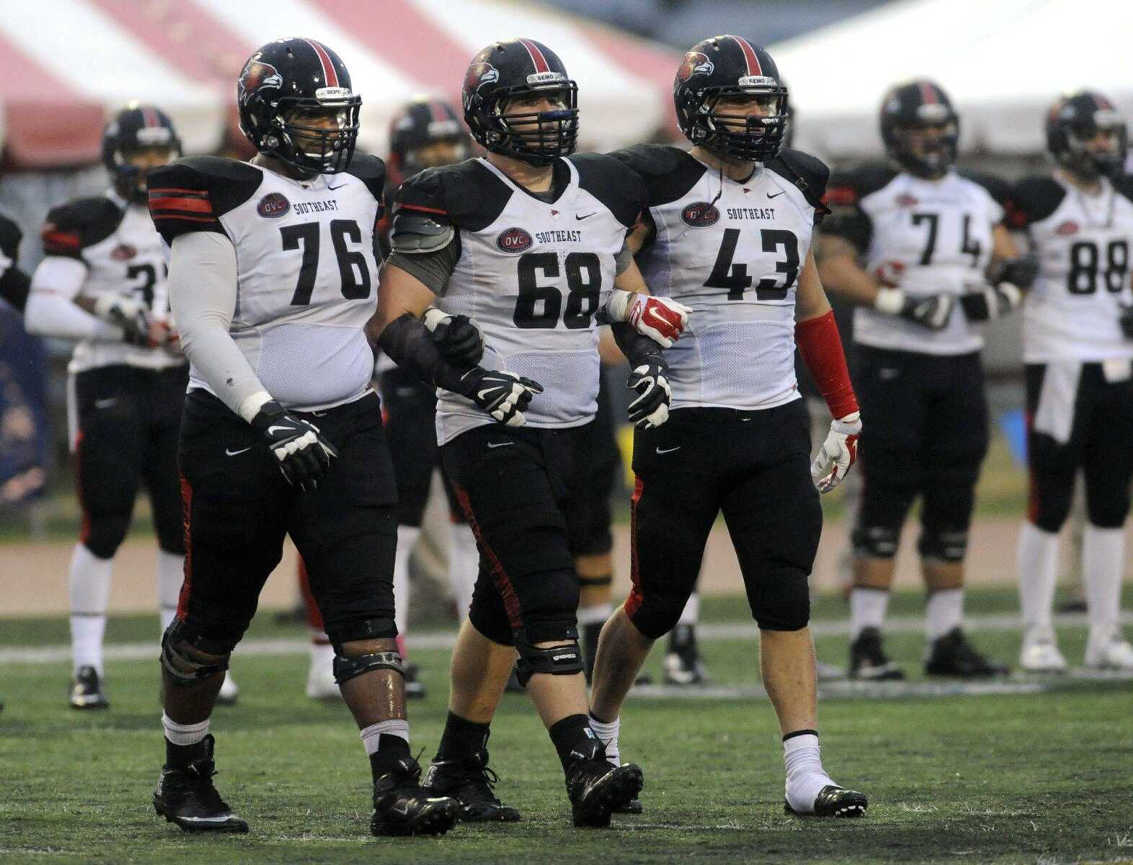 Corey Porter, left, Jon Slania and Roper Garrett walk out for the overtime coin toss at Murray State last season in Murray, Kentucky.