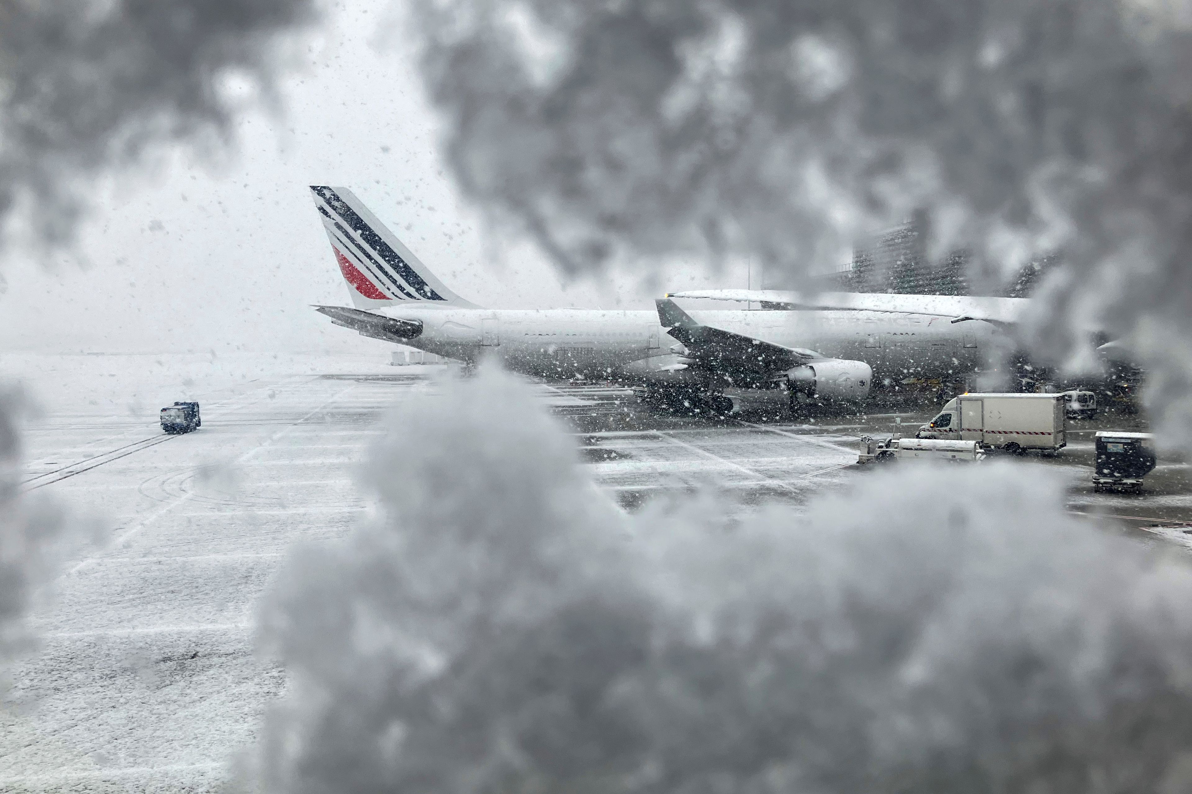 An Air France plane sits on the tarmac during a snowfall at Charles de Gaulle airport, north of Paris, Thursday, Nov. 21, 2024. (AP Photo/Masha Macpherson)