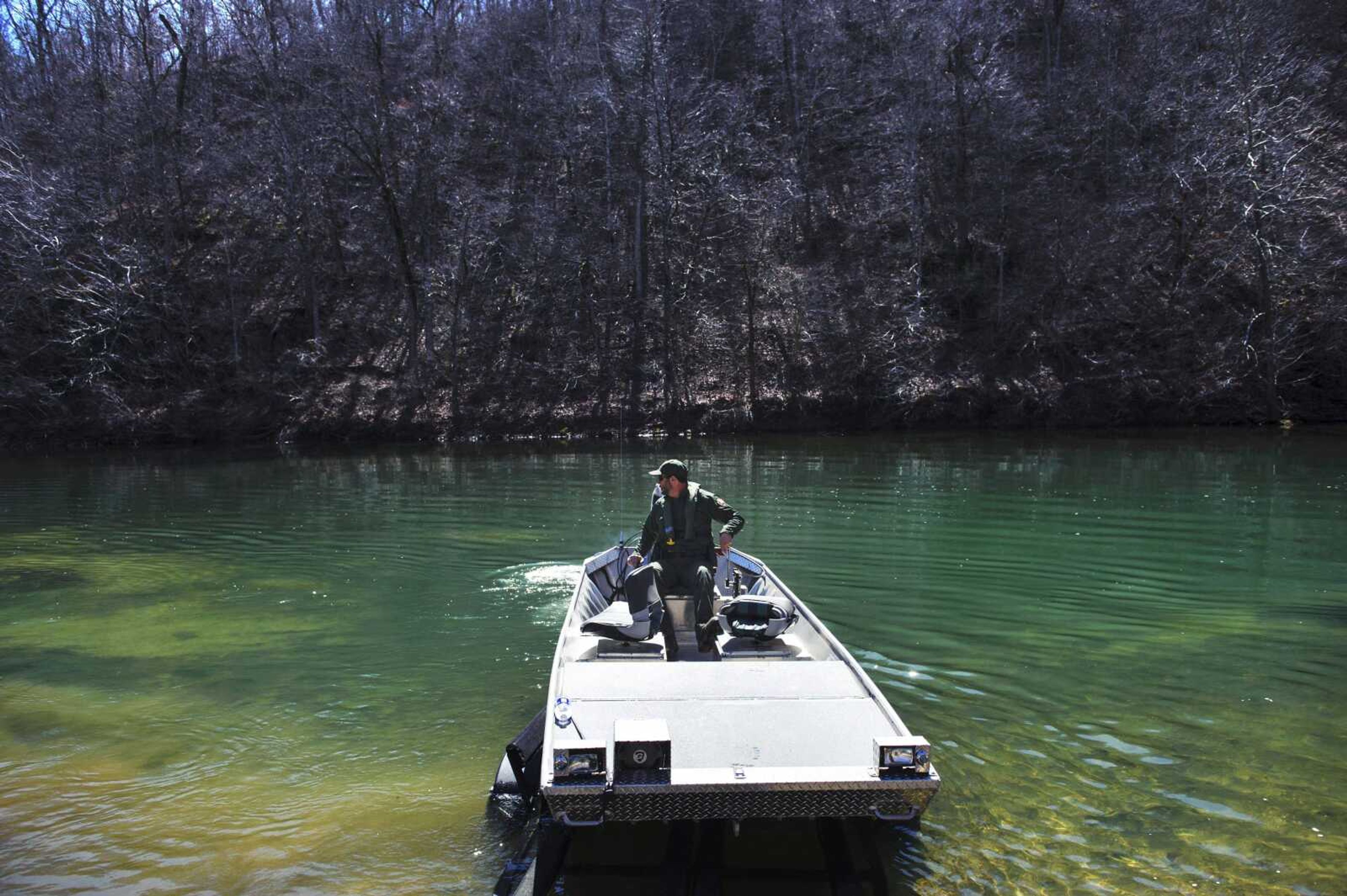 In this Thursday, March 20, 2014, photo, park ranger Austin Konkel puts his boat in on the Current River in the Ozark National Scenic Riverways. Following last year's government shutdown and a proposed new management plan for the park, some are calling for the federal government to turn it over to the state. (AP Photo/The Columbia Daily Tribune, Ryan Henriksen)