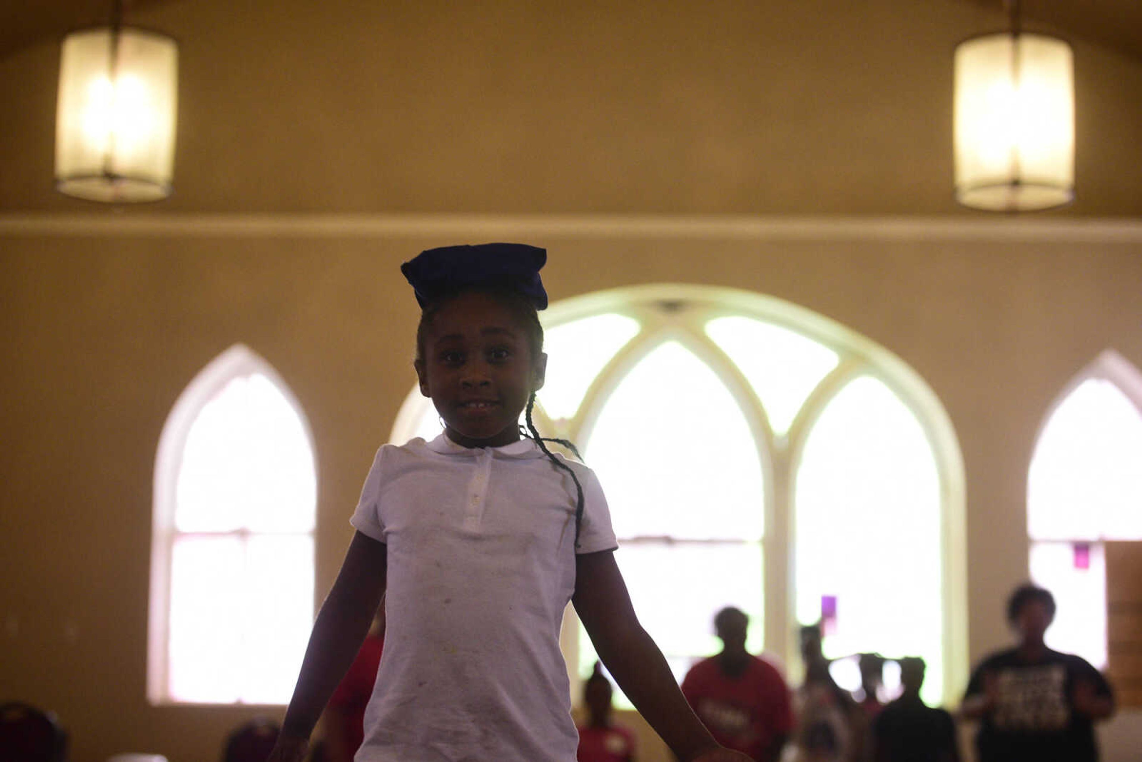 Alexya Jones tries to balance a small sandbag on her head without having it slide off on Monday, Aug. 14, 2017, during the Salvation Army's after school program at The Bridge Outreach Center in Cape Girardeau.