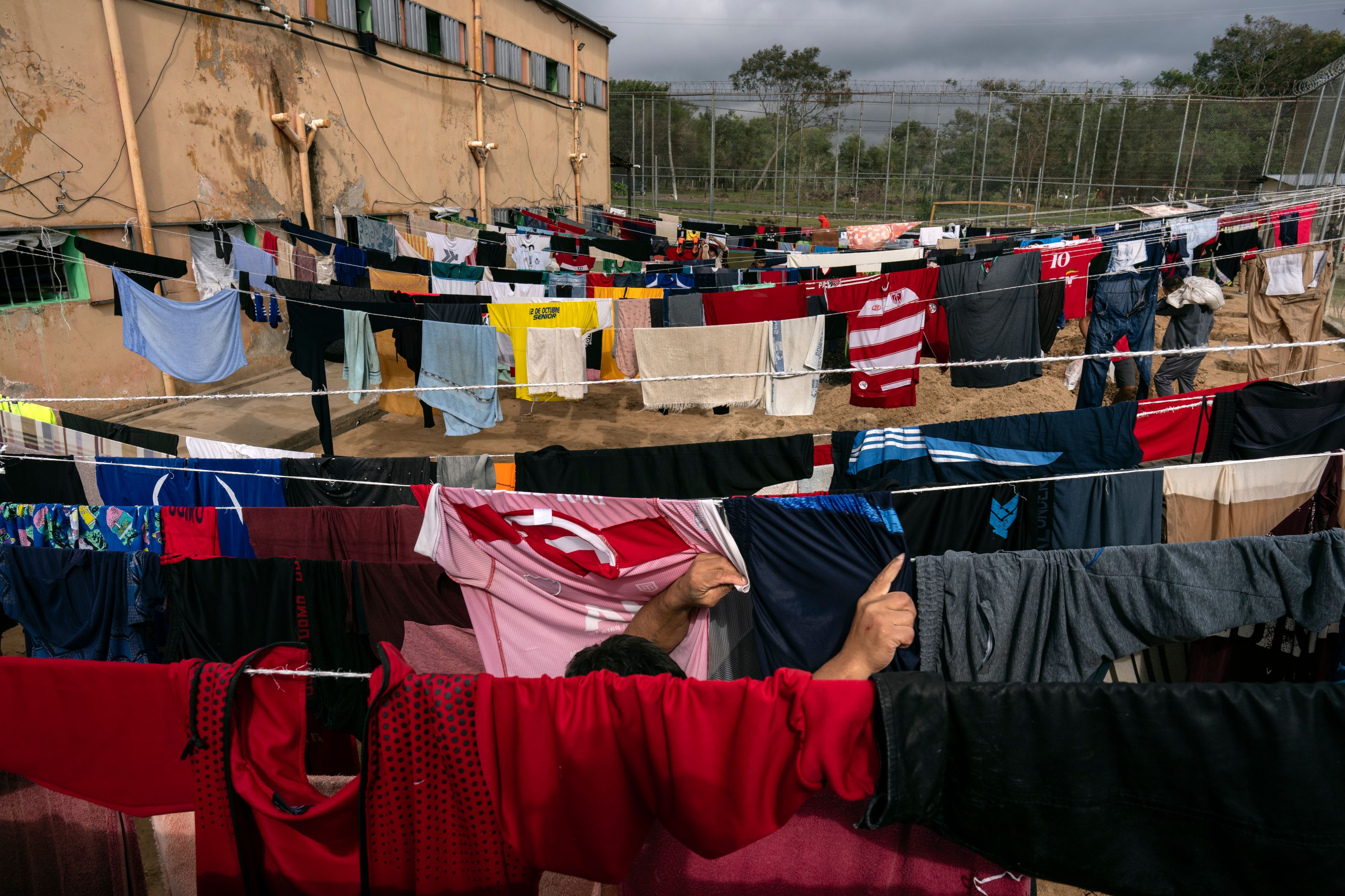 A prisoner hangs clothes to dry outside at the Juan de la Vega prison in Emboscada, Paraguay, Friday, July 12, 2024. (AP Photo/Rodrigo Abd)