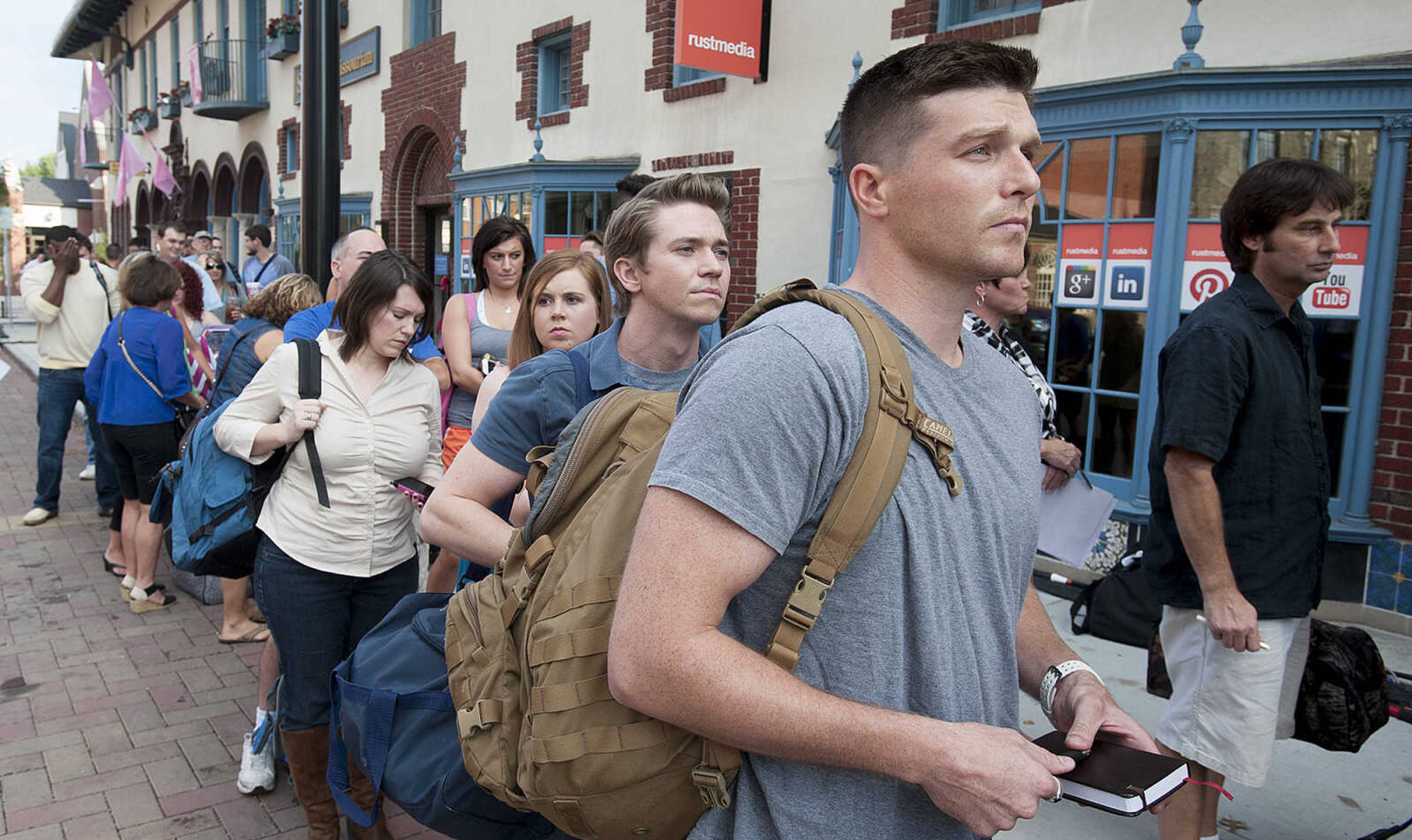 ADAM VOGLER ~ avogler@semissourian.com
Extras working on the 20th Century Fox feature film "Gone Girl," wait in line to check in before filming a sceneThursday, Oct. 3, in downtown Cape Girardeau.