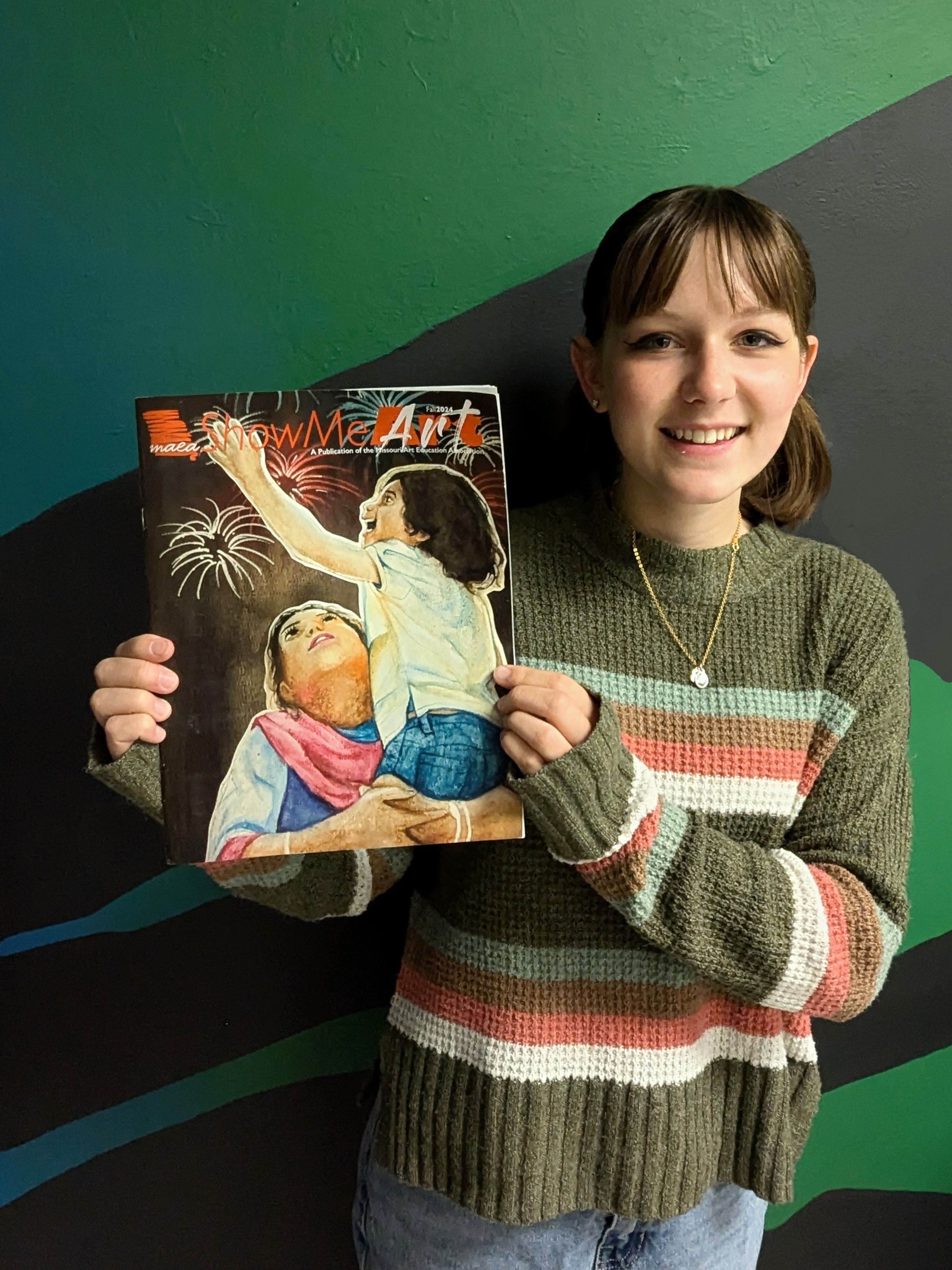 Cape Central High School senior Caitlin Hill with the Fall 2024 Show Me Art Magazine!, which features her art on the cover. 