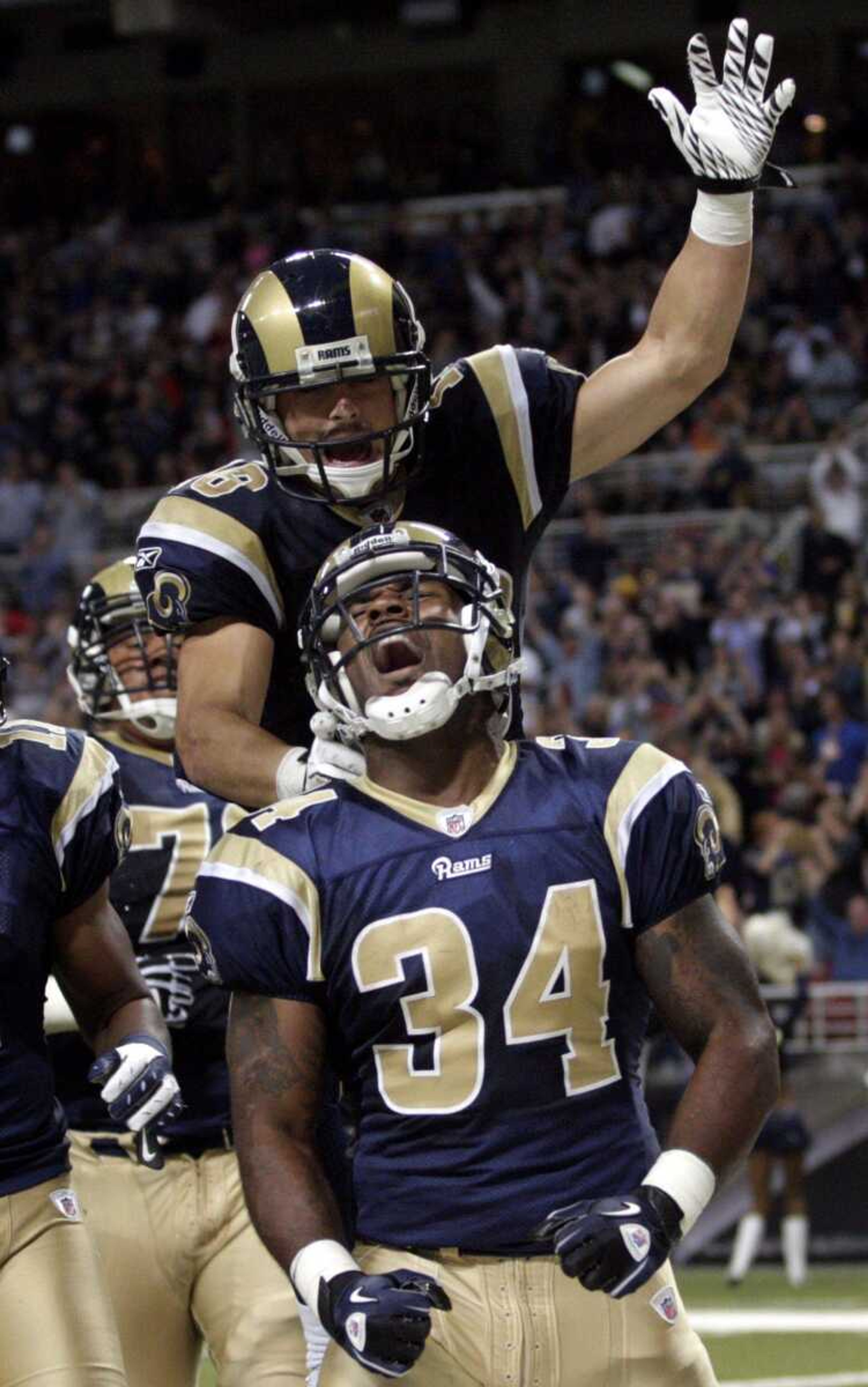 Rams running back Kenneth Darby is congratulated by teammate Danny Amendola after scoring against the Redskins on a 12-yard run during the third quarter Sunday in St. Louis. (Tom Gannam ~ Associated Press)