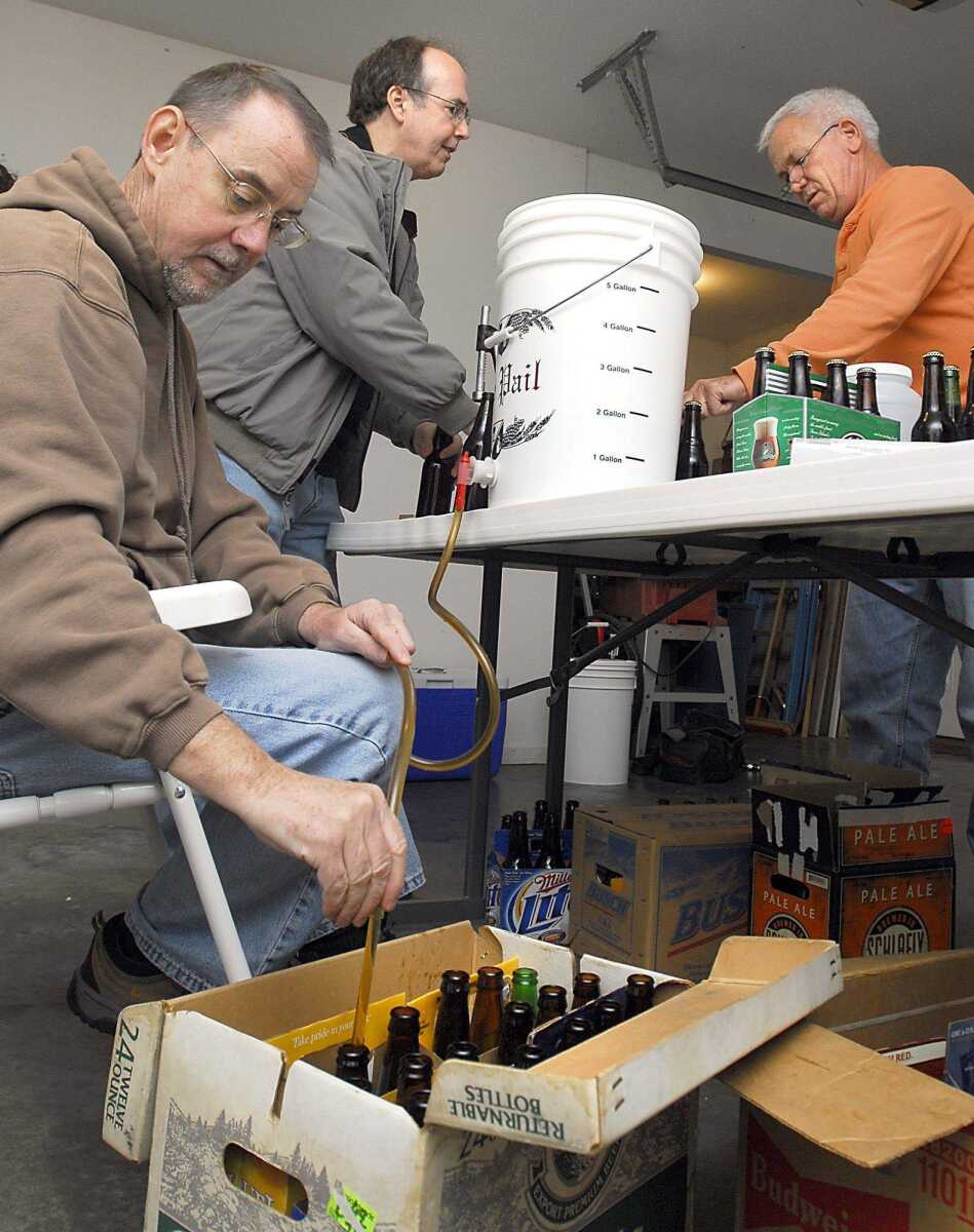 St. Mark's Spirits Club members, from left, Ken Green, Steven Hoffman and Fred Grabel, bottled their brew in Grabel's garage. (Fred Lynch)