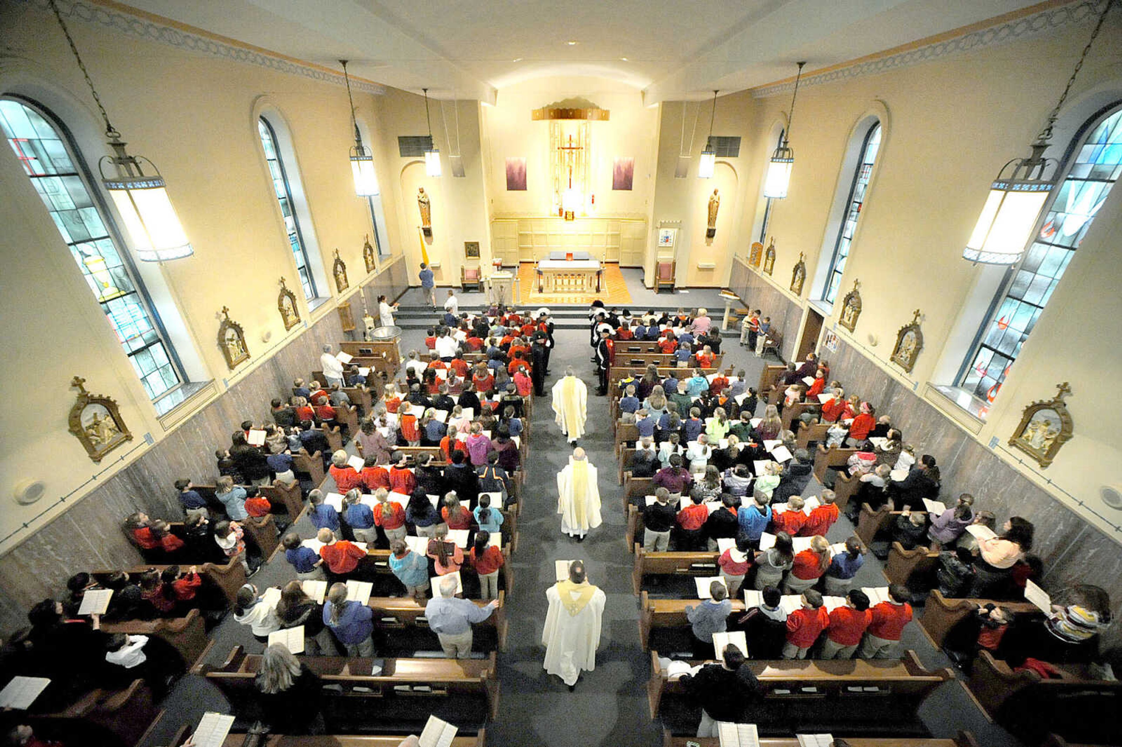 LAURA SIMON ~ lsimon@semissourian.com
Parishioners and students stand as they sing at the beginning of the Mass of Thanksgiving at St. Mary's Cathedral Friday morning, March 15, 2013 in Cape Girardeau. The mass was in honor of the election of Pope Francis I.