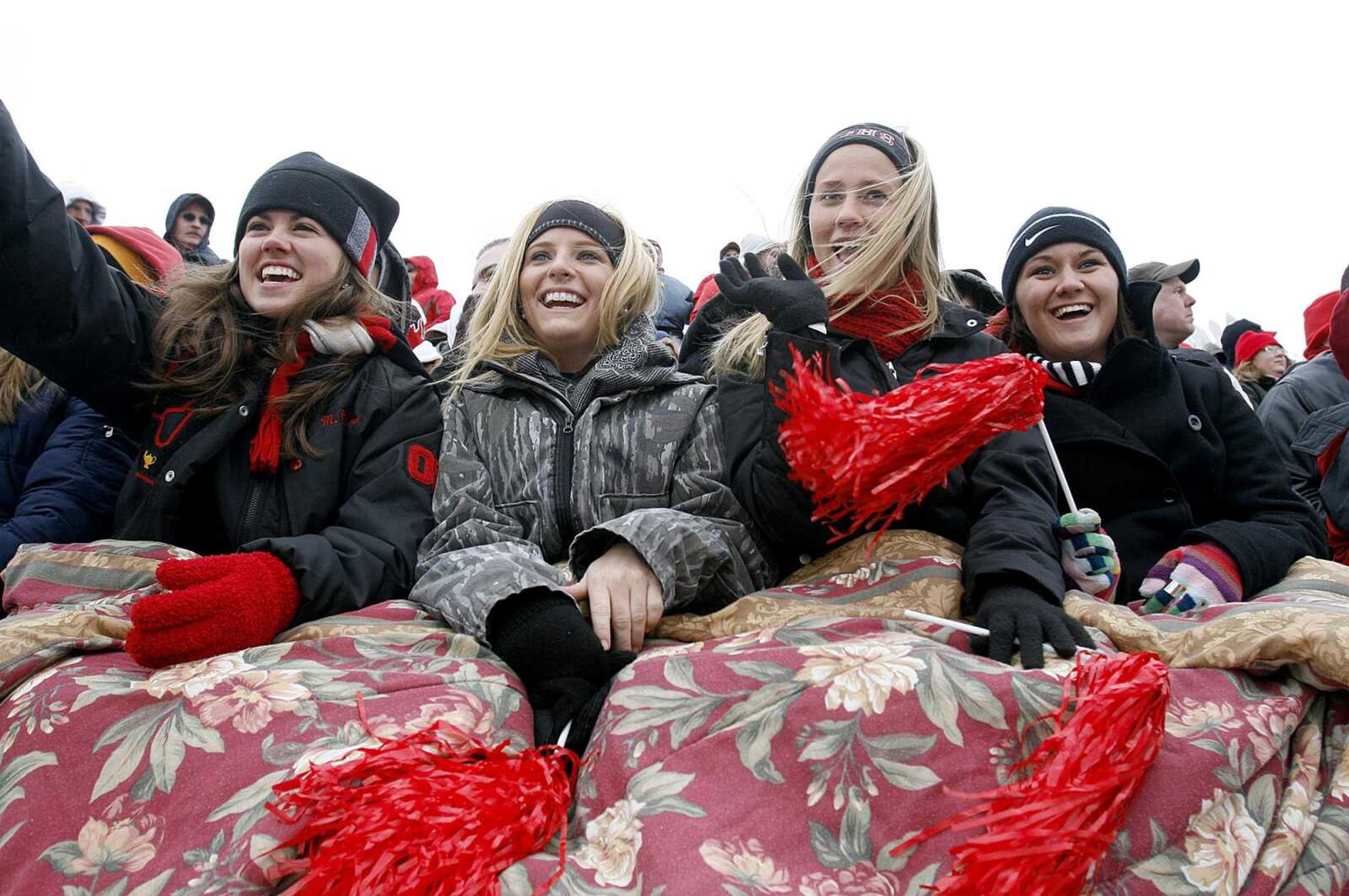 ELIZABETH DODD ~ edodd@semissourian.com
Seniors from Jackson Marlana McDowell, from left, Kyla Wills, Bobbi Jo Schlick and Kaley Wachter wave to friends while staying warm before the start of the game.