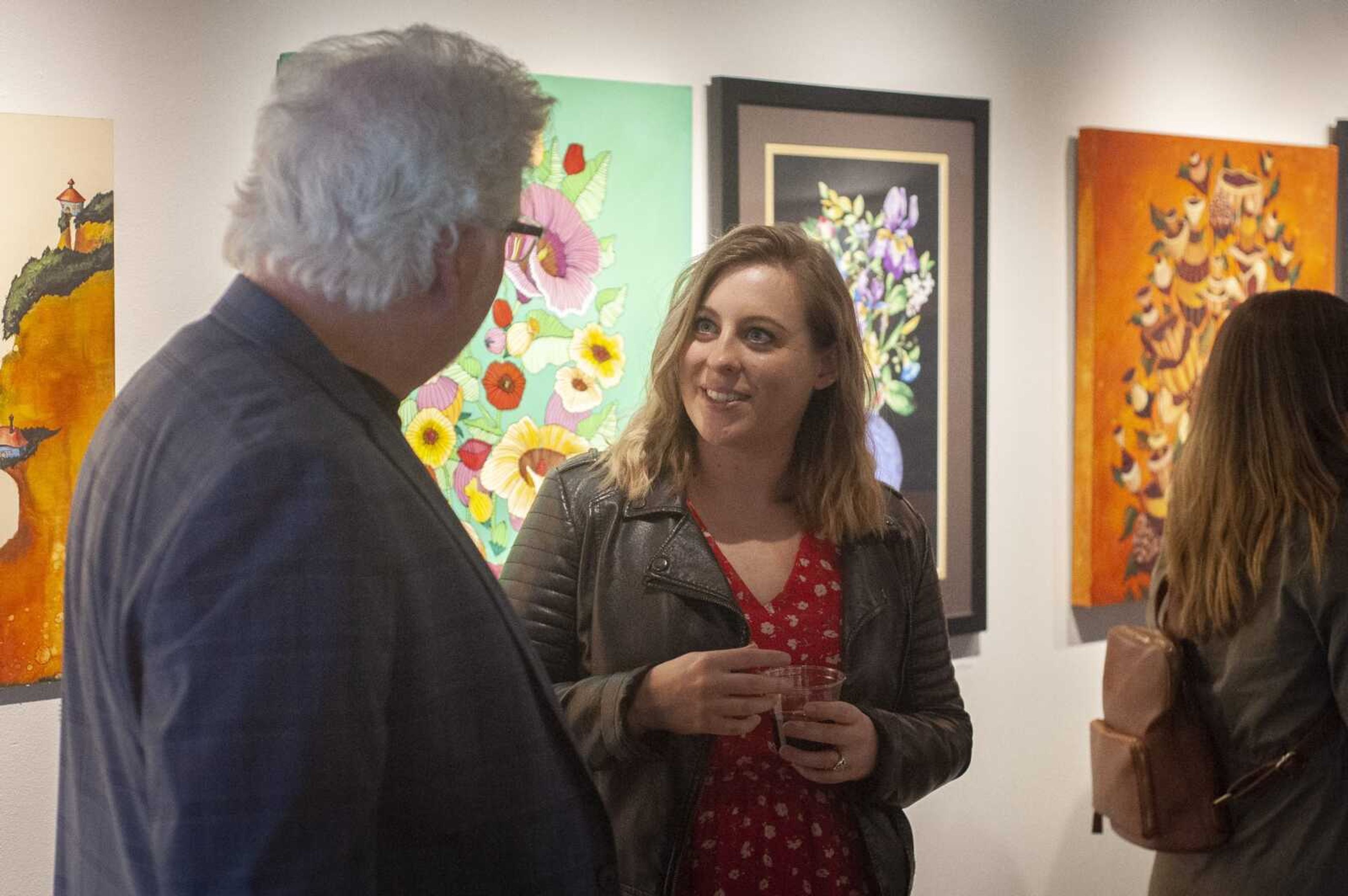 Dave Walker and Hannah Smith discuss their works in the show "Interpretations: Dad and Daughter" at the opening reception Friday, March 6, 2020, at the Arts Council of Southeast Missouri, 16 N. Spanish St. in Cape Girardeau.