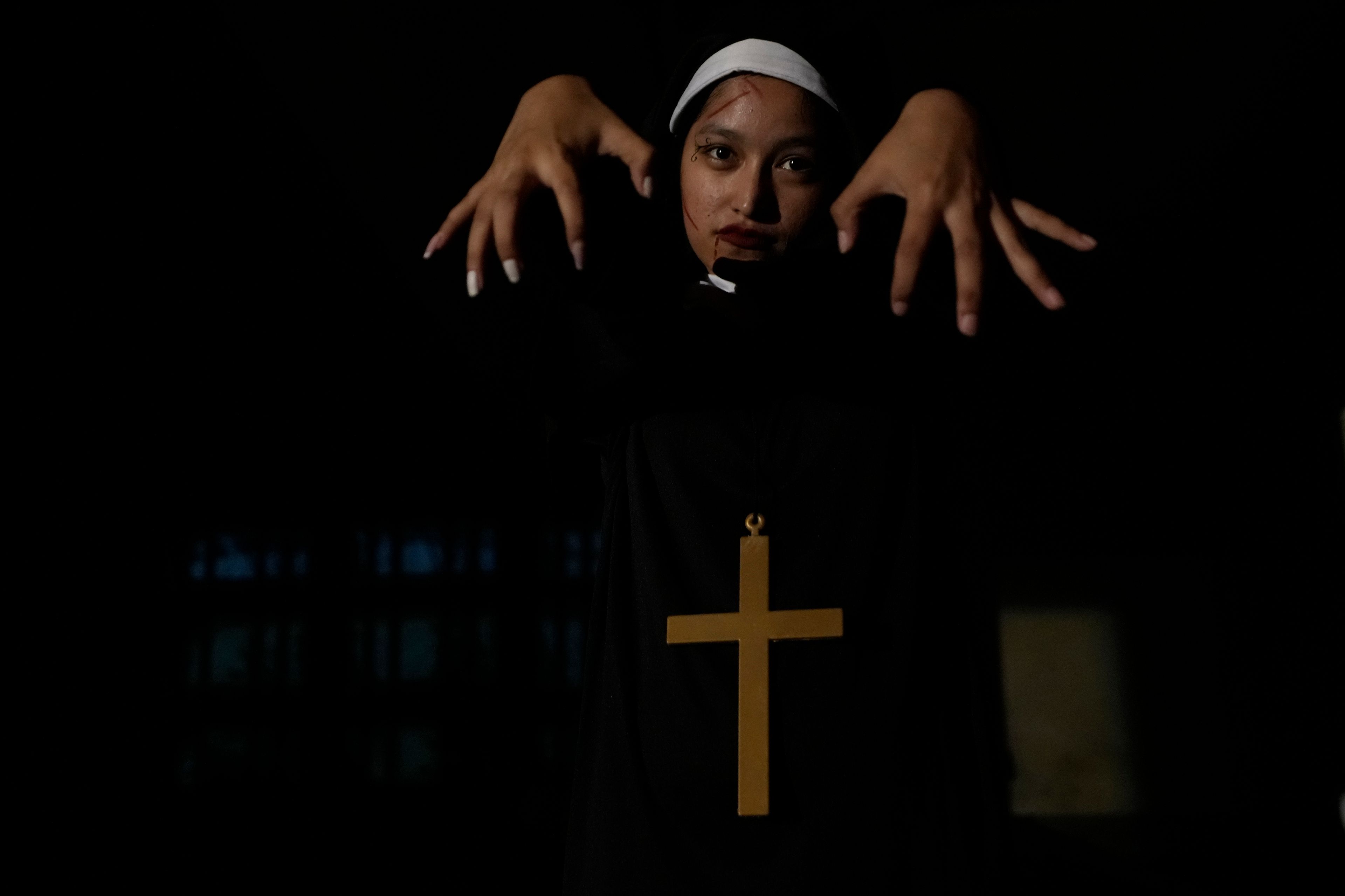 A visitor dressed in a ghost costume at Goosebump market as a part of Halloween festival in Bangkok, Thailand, Wednesday, Oct. 30, 2024. (AP Photo/Sakchai Lalit)