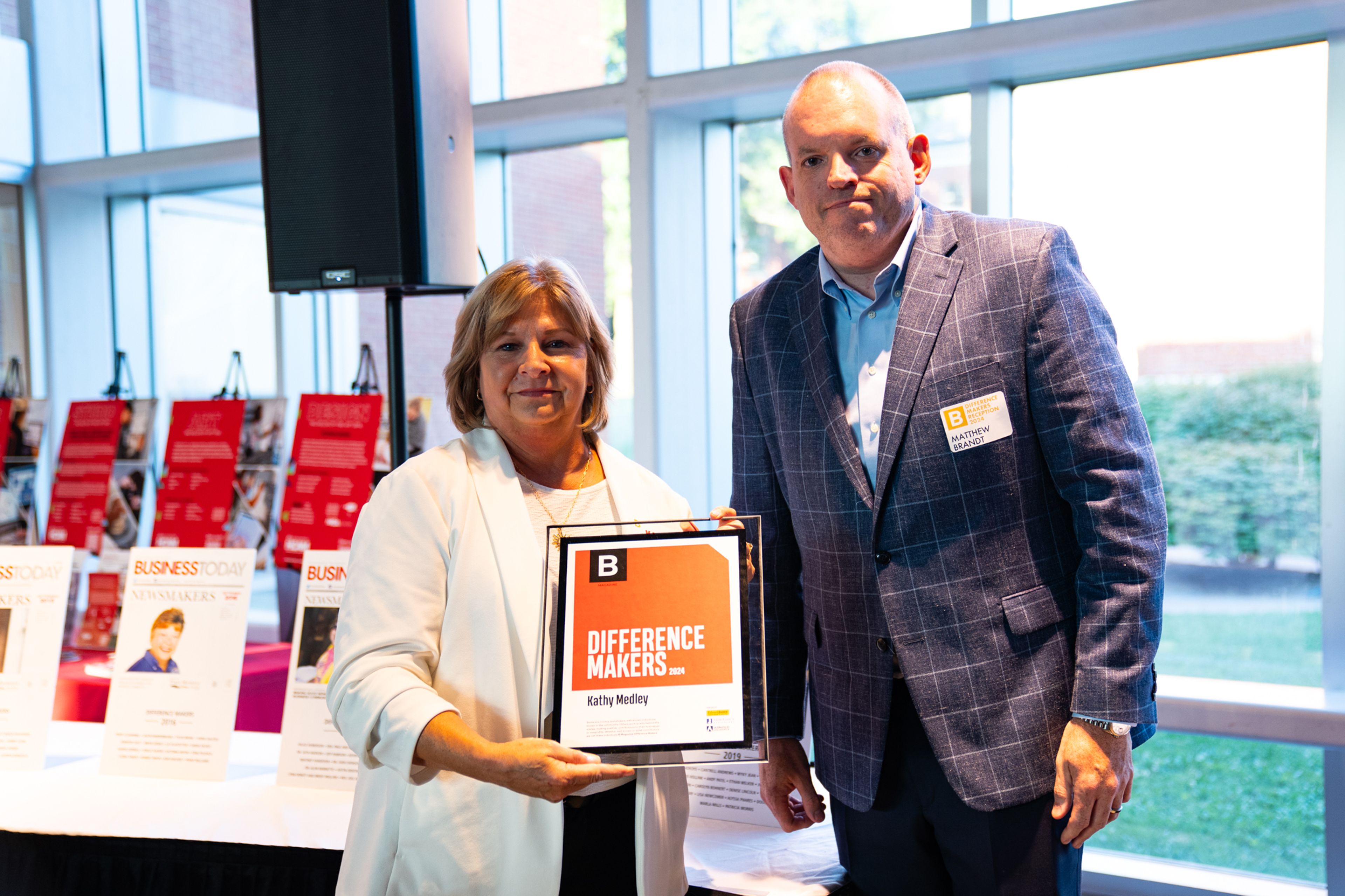 Kathy Medley receives a plaque from Saint Francis Healthcare System’s Matthew Brandt recognizing her as a 2024 Difference Maker at their reception at Southeast Missouri State University’s River Campus. The Difference Maker’s reception was presented by B Magazine on Thursday, Sept. 6.