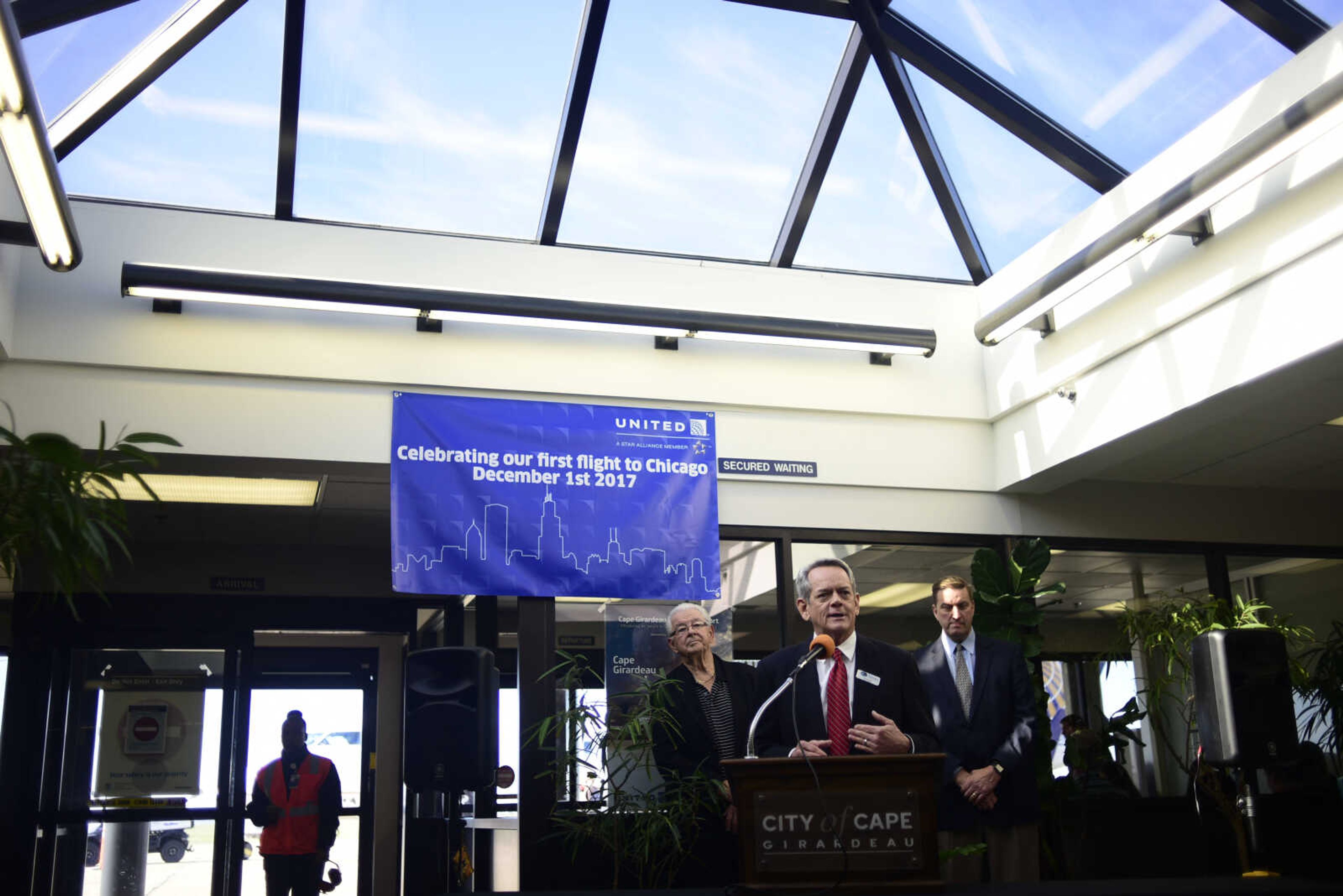 Airport manager Bruce Loy speaks withHarry Rediger, left, and Scott Meyer, right, during the inaugural trip to Chicago on a CRJ200 airplane with SkyWest Friday, Dec. 1, 2017 at Cape Girardeau Regional Airport in Cape Girardeau.