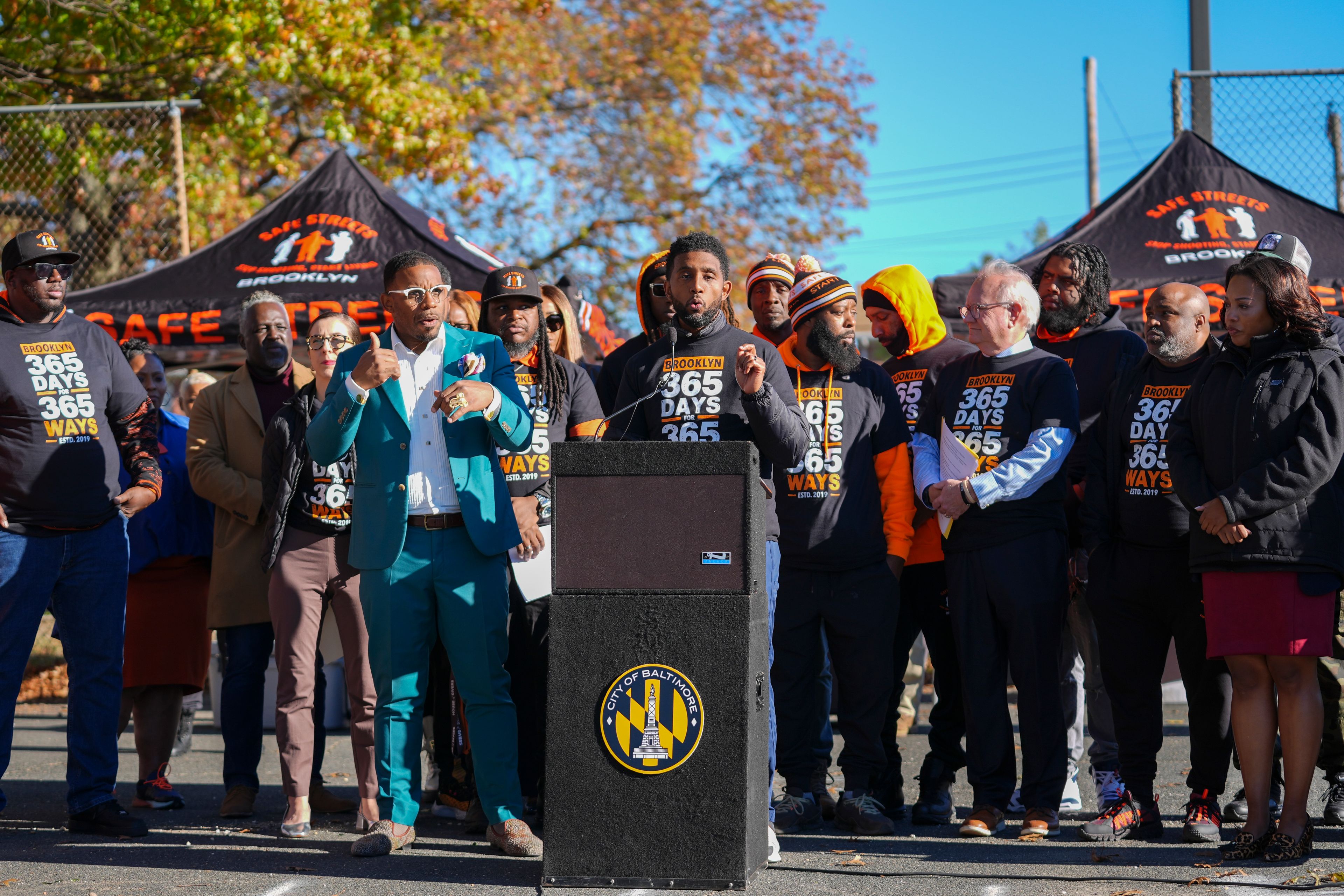 Baltimore Mayor Brandon Scott, center, speaks during a press conference to celebrate achieving over 365 days without a homicide within the Brooklyn neighborhood Safe Streets catchment zone, Tuesday, Nov. 12, 2024, in Baltimore. (AP Photo/Stephanie Scarbrough)