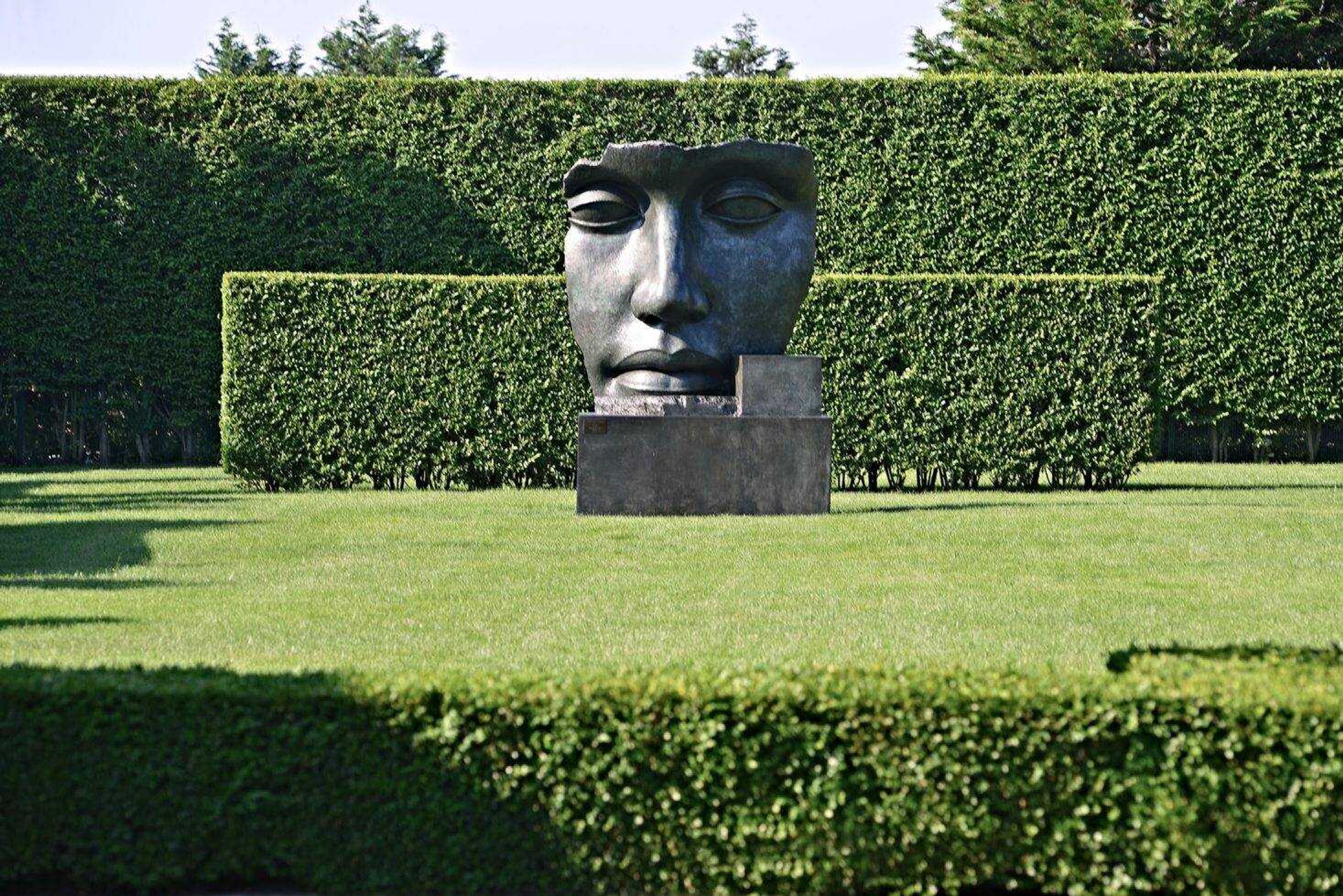 This undated photo provided by The Monacelli Press shows  Per Adriano  by sculptor Igor Mitoraj in a residential garden on the east end of Long Island in New York. The garden was designed by landscape architect Edmund Hollander. (Charles Mayer/The Monacelli Press via AP)