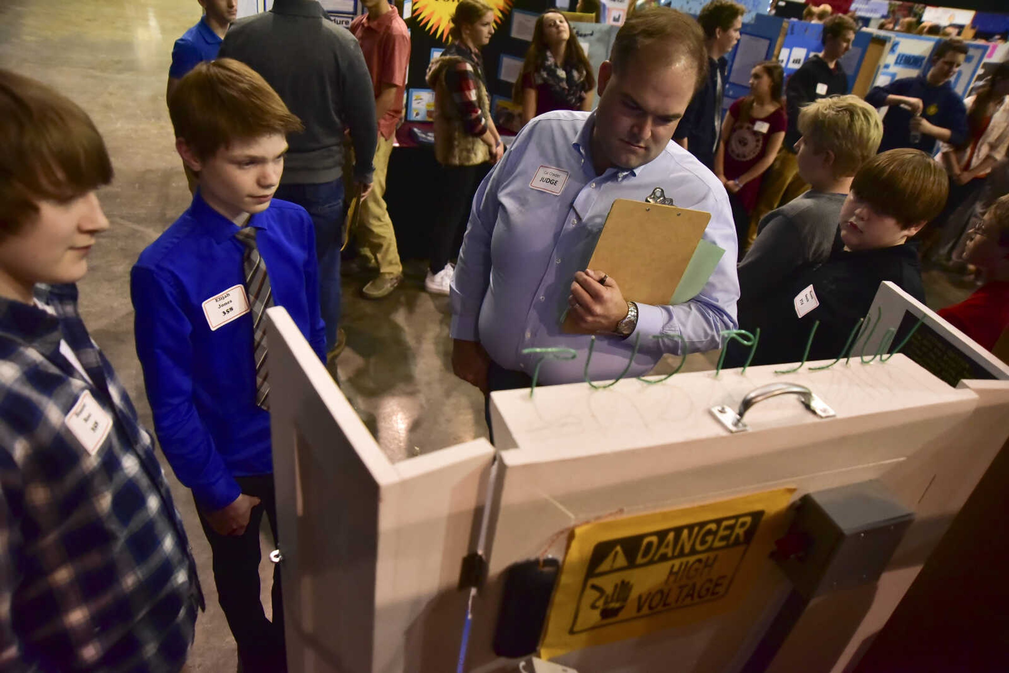 Judge Cal Crader, right, looks over Elijah Jones's science project during the Southeast Missouri Regional Science Fair Tuesday, March 7, 2017 at the Show Me Center in Cape Girardeau.