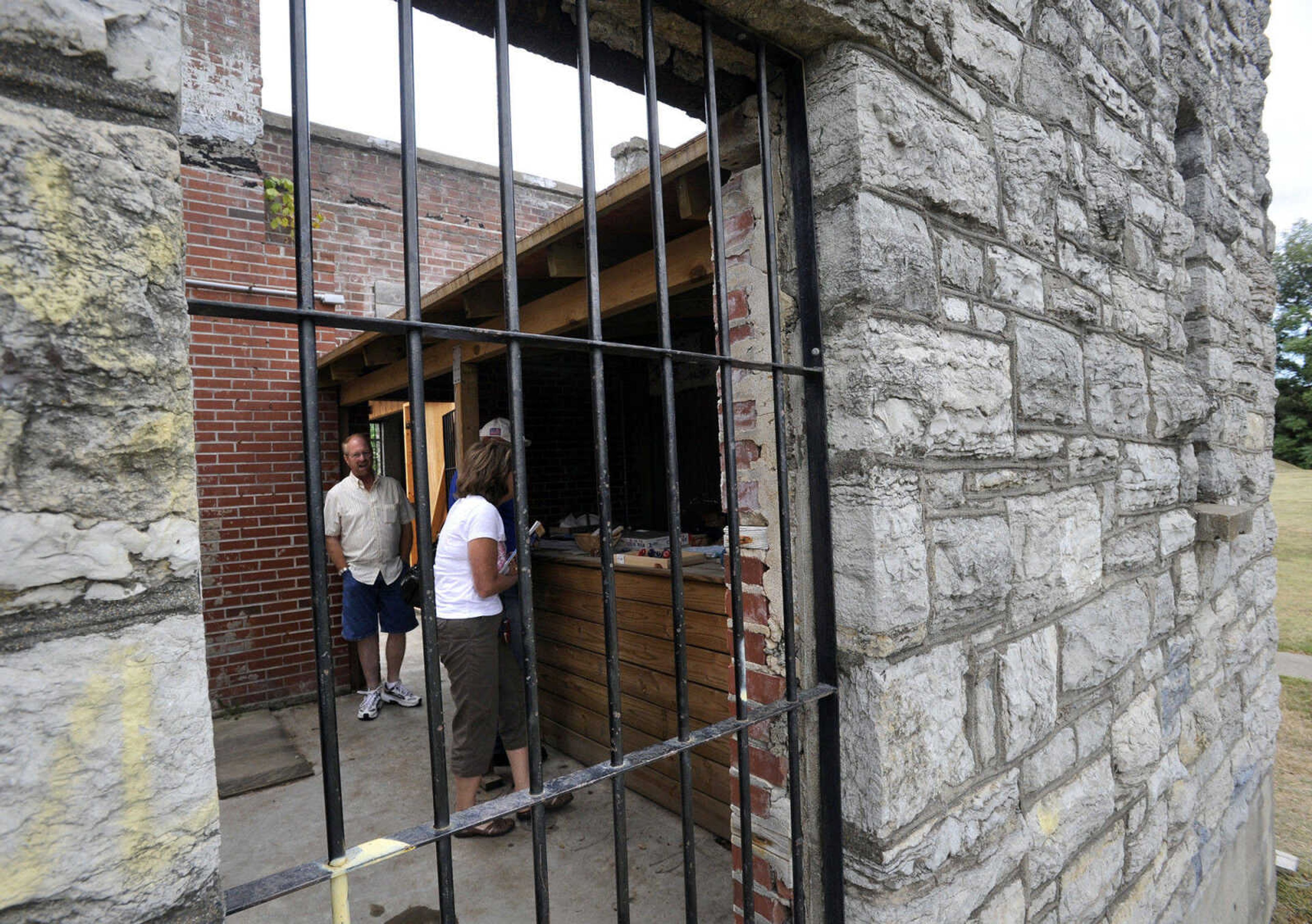 Visitors walk through the open-air stone building at Fort D.