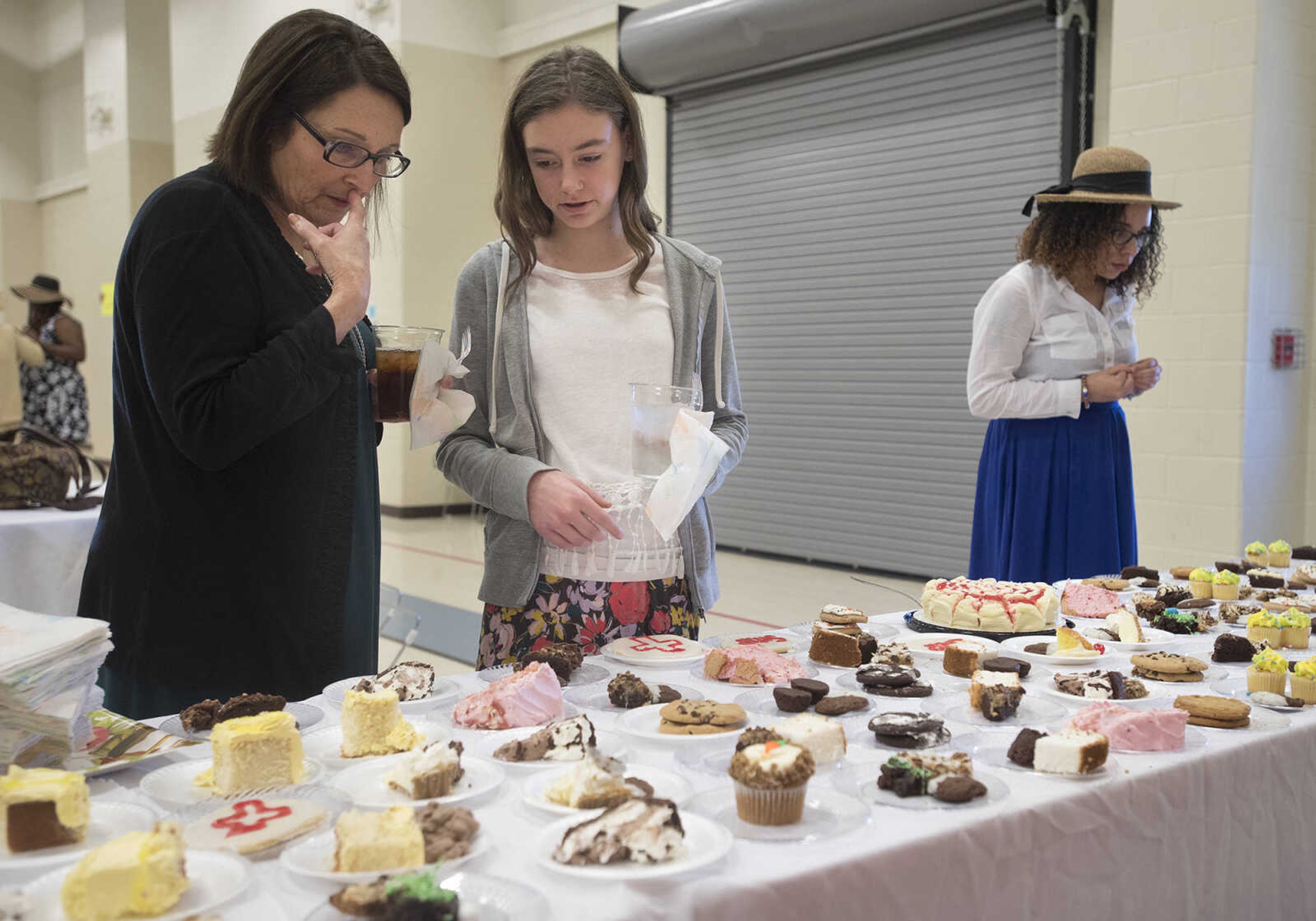 Women select desserts during a ladies' tea and sweets event hosted by Stop Needless Acts of Violence Please on April 1, 2017 at the Shawnee Park Center in Cape Girardeau.