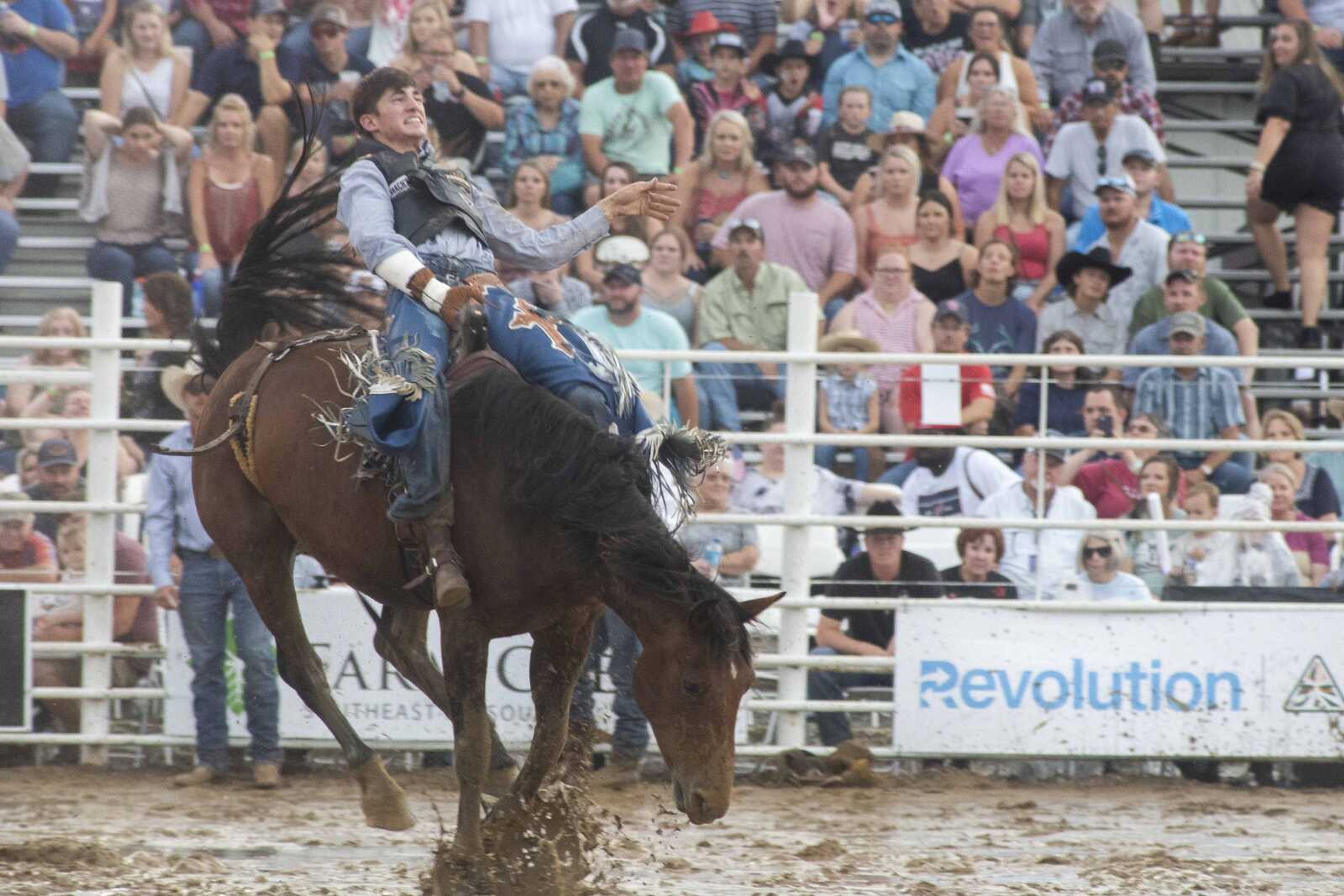 &nbsp;A performer holds on tight during a muddy night at the Sikeston Jaycee Bootheel Rodeo Friday, Aug. 13, 2021,&nbsp;in Sikeston, Missouri.