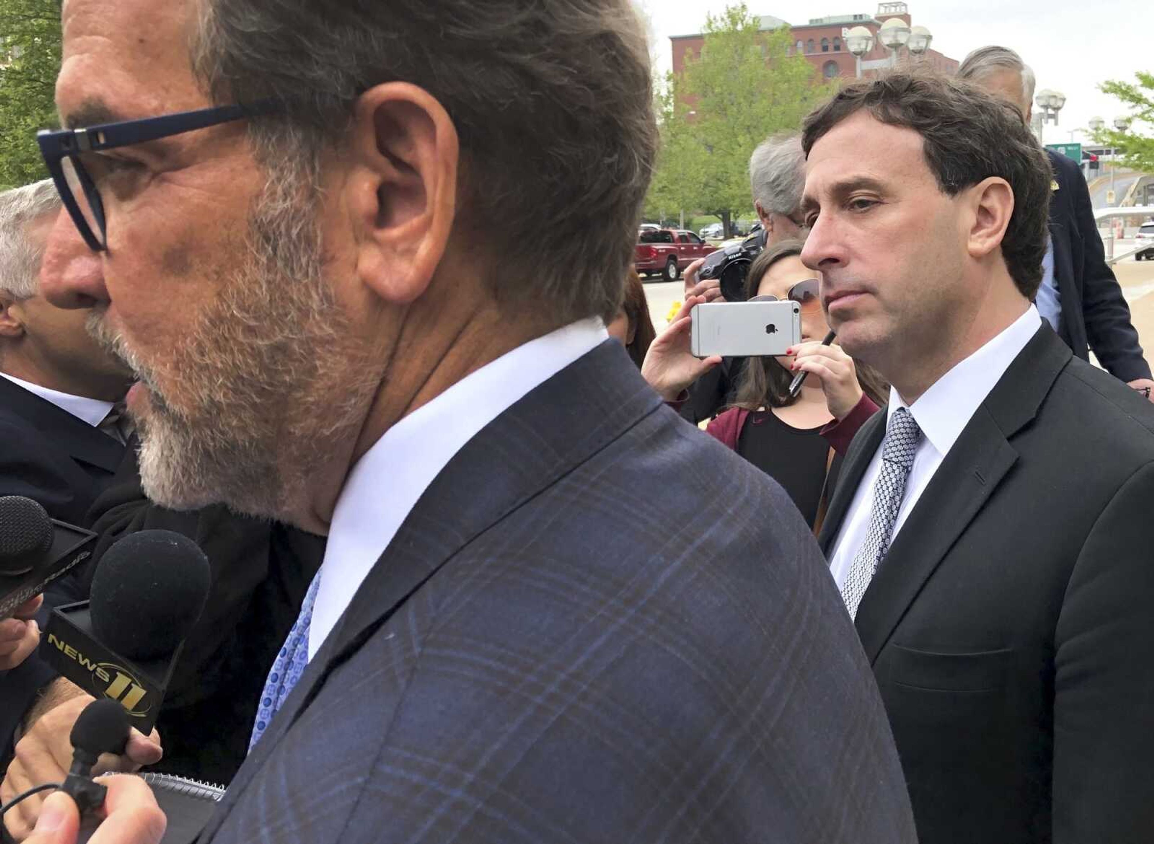 Former St. Louis County Executive Steve Stenger, right, listens as his attorney, Scott Rosenblum, speaks to a reporter May 3 in St. Louis after Stenger pleaded guilty to federal corruption charges and faces sentencing in August.