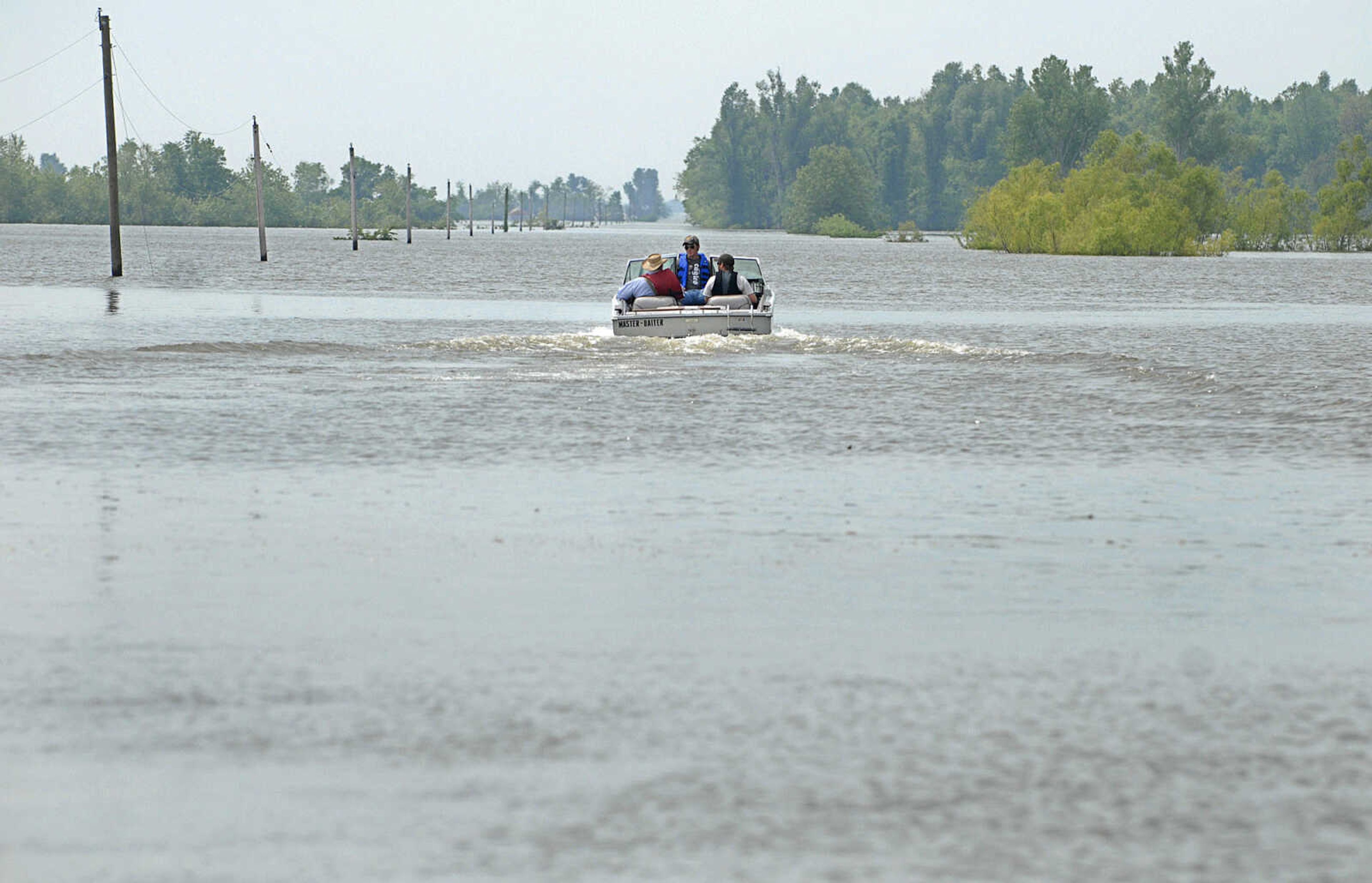 LAURA SIMON~lsimon@semissourian.com
Claude Thomure, his grandson Eric Thomure, and worker Chris Byasse set off along Highway 102 Monday, May 9, 2011 to check on Thomure's property in the Mississippi County floodway.