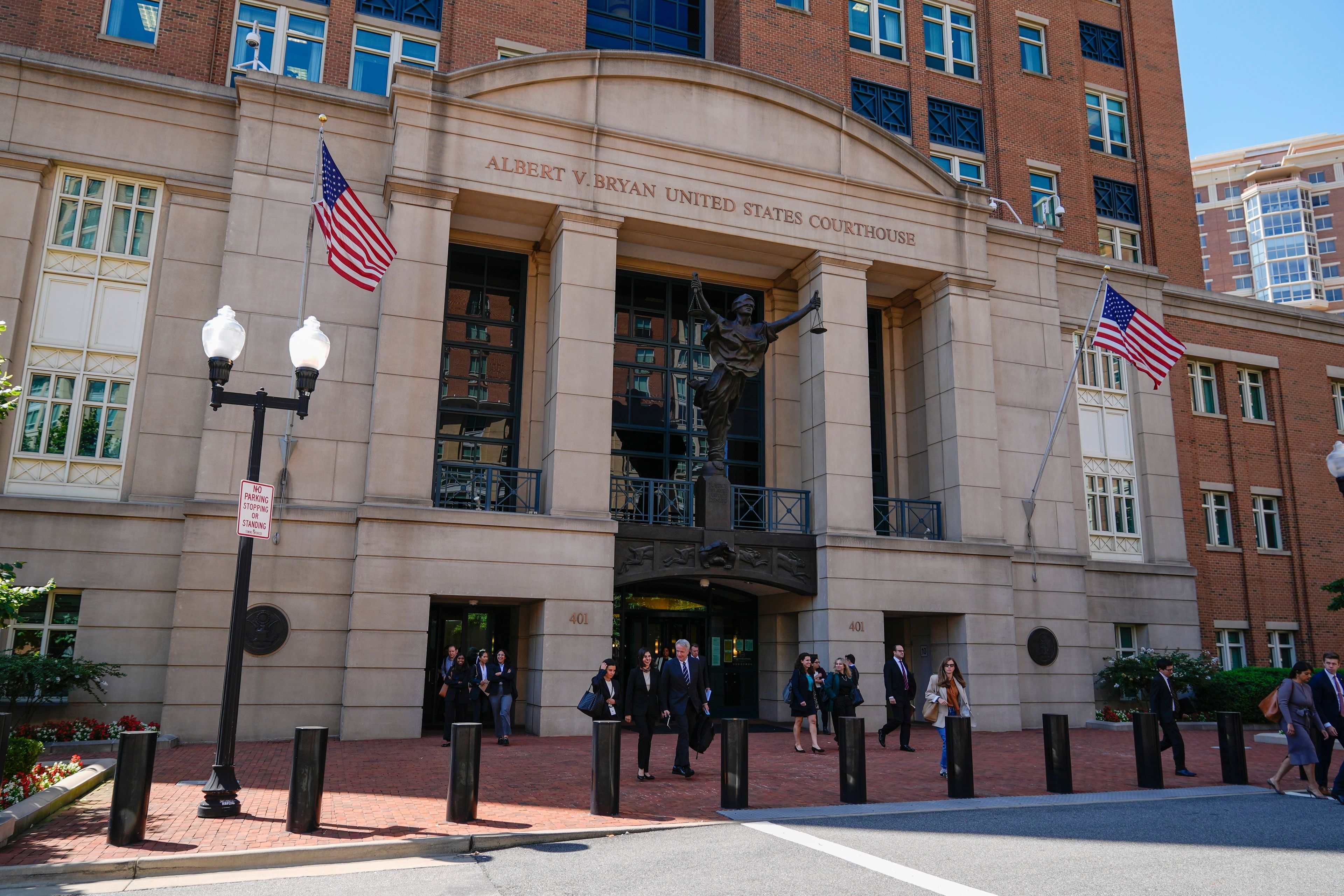 Lawyers leave the U.S. District Court for the Eastern District of Virginia for a lunch break in the Department of Justice's antitrust trial against tech giant Google, Monday, Sept. 9, 2024, in Alexandria, Va. One month after a judge declared Google's search engine an illegal monopoly, the tech giant faces another antitrust lawsuit that threatens to break up the company, this time over its advertising technology. (AP Photo/Stephanie Scarbrough)