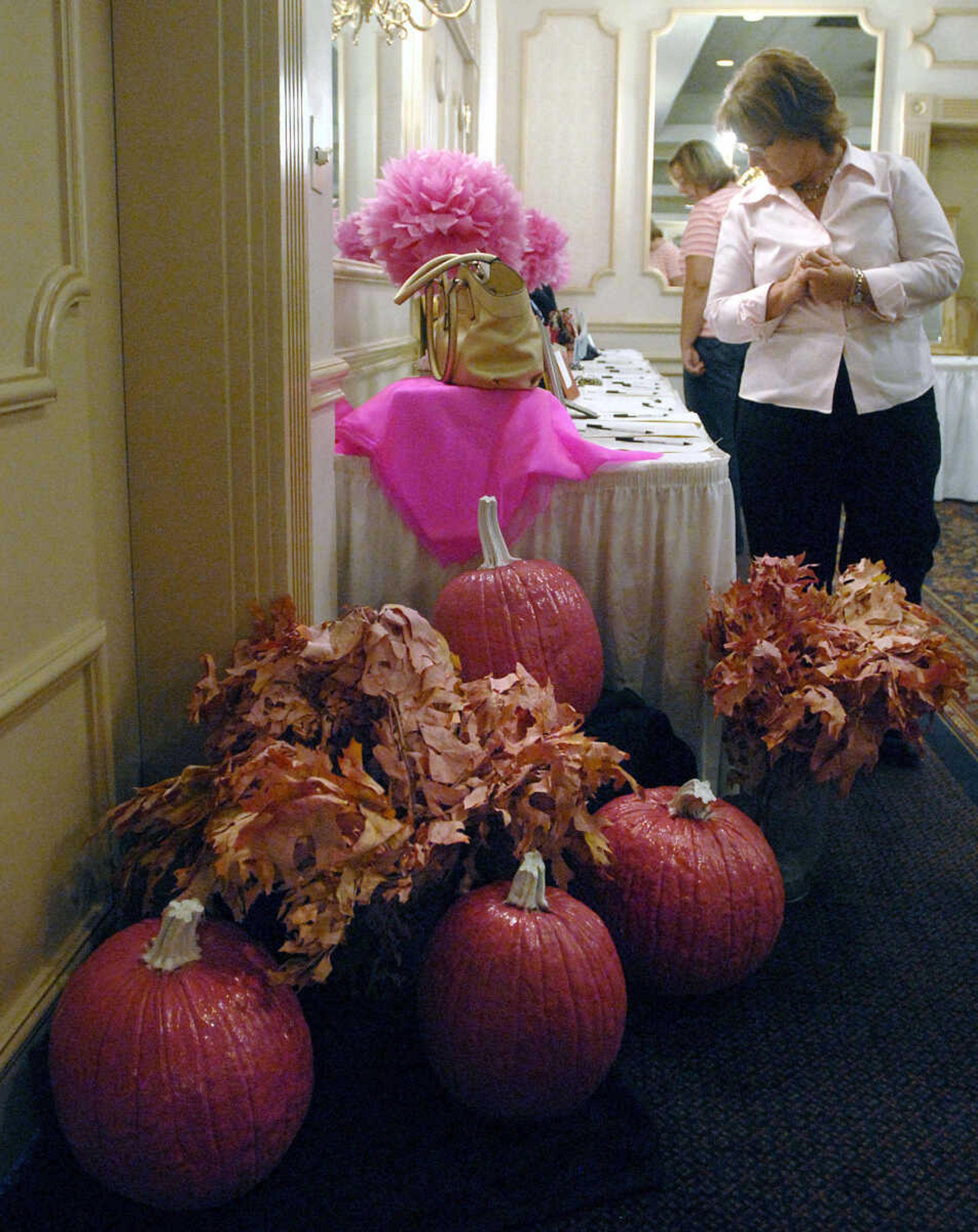 LAURA SIMON ~ lsimon@semissourian.com
People look over items up for bid in the silent auction during the 8th annual American Cancer Society Pink Ribbon Luncheon Wednesday, October 12, 2011 at Drury Lodge in Cape Girardeau. The luncheon featured a silent auction, live purse auction, speakers Lisa howe, Julie Metzger, Priscilla Mabuse and Lori Faire. All proceeds of the luncheon benefit cancer patients in southeast Missouri through the American Cancer Society's Cape Area Patient Service Fund.