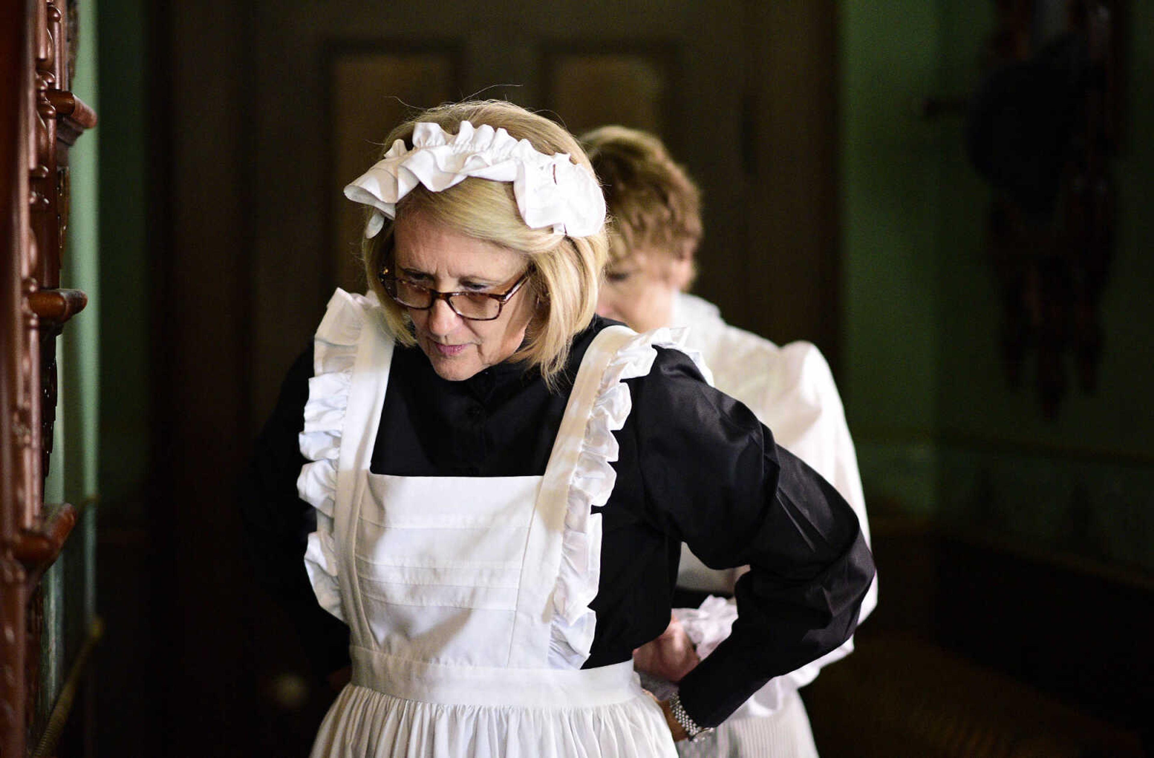 Jane Stephens helps Linda Ingram with her period costume on Wednesday, Aug. 16, 2017. Stephens and Ingram were both in period costumes as part of KMOS-TV's, a PBS affiliate, filming for Missouri Life inside the Glenn House in Cape Girardeau.