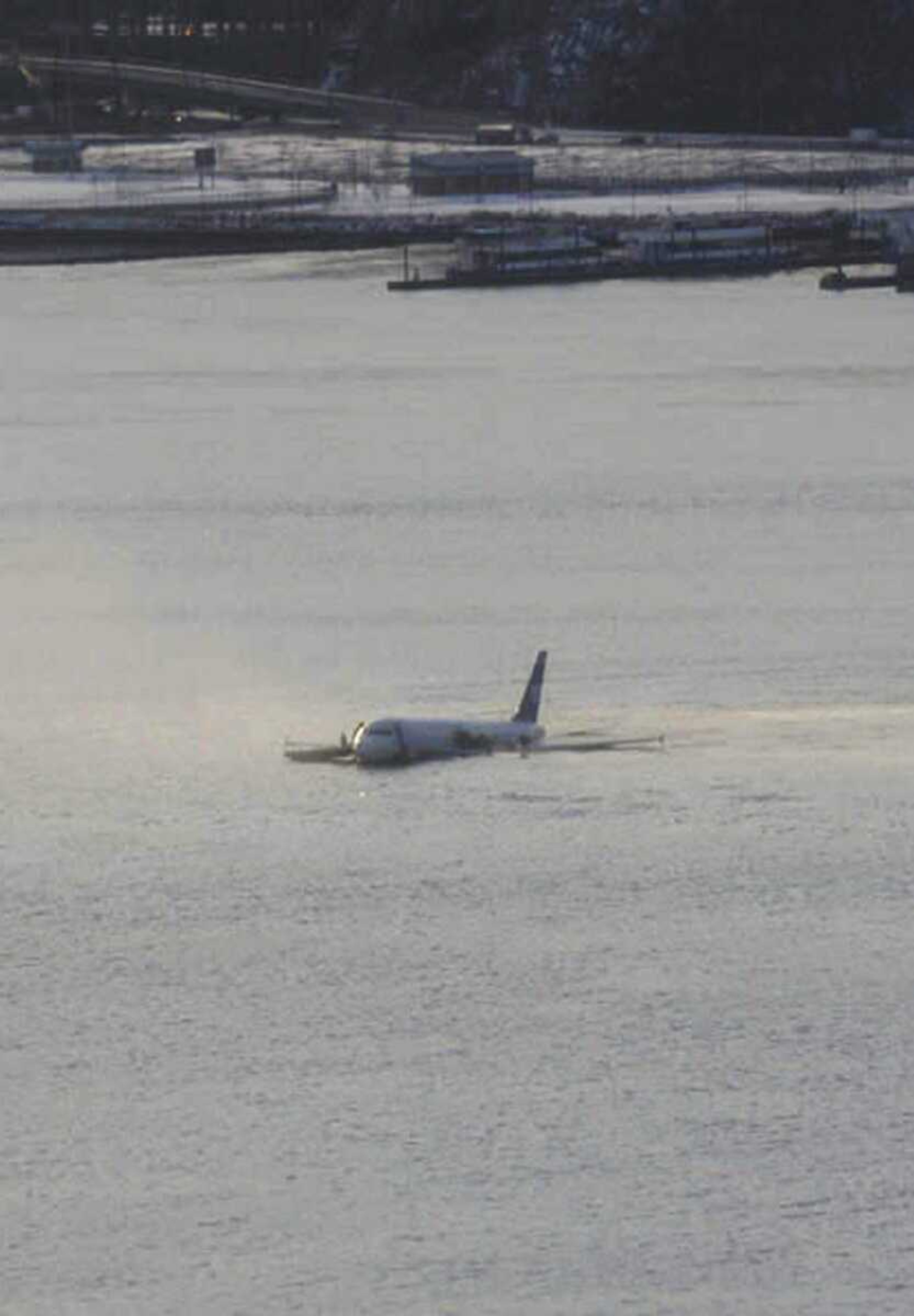 A US Airways jetliner is seen after it crashed into the Hudson River Thursday afternoon, Jan. 15, 2009 after a flock of birds apparently disabled both its engines. Rescuers pulled the more than 150 passengers and crew members into boats before the plane sank, authorities say. Federal Aviation Administration spokeswoman Laura Brown said Flight 1549 had just taken off from LaGuardia Airport en route to Charlotte, N.C., when the crash occurred in the river near 48th Street in midtown Manhattan. (AP Photo/Greg Lam Pak Ng)