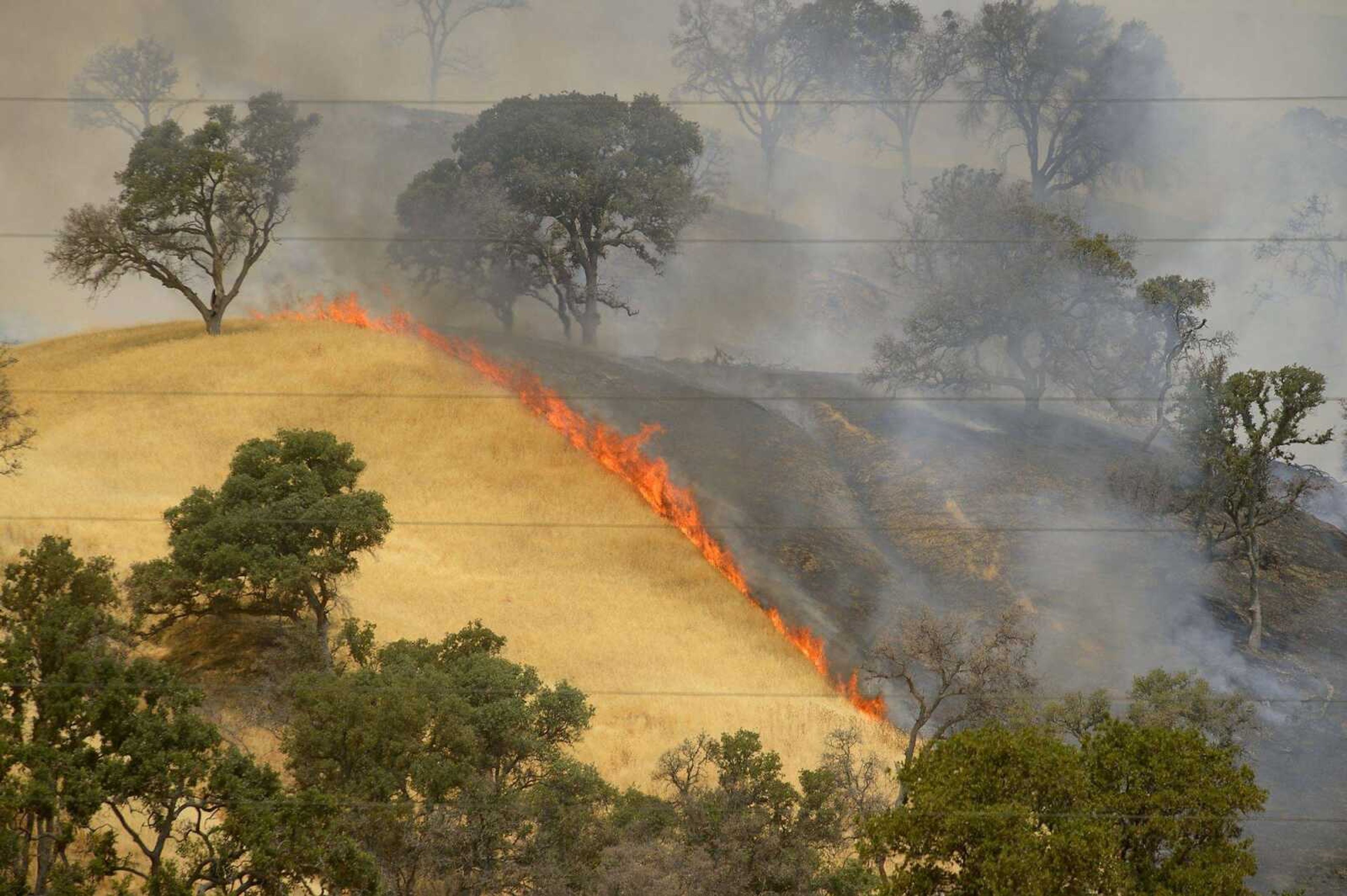 Fire burns the hillsides as the County Fire continues along Highway 129 near Lake Berryessa in Yolo County, California.