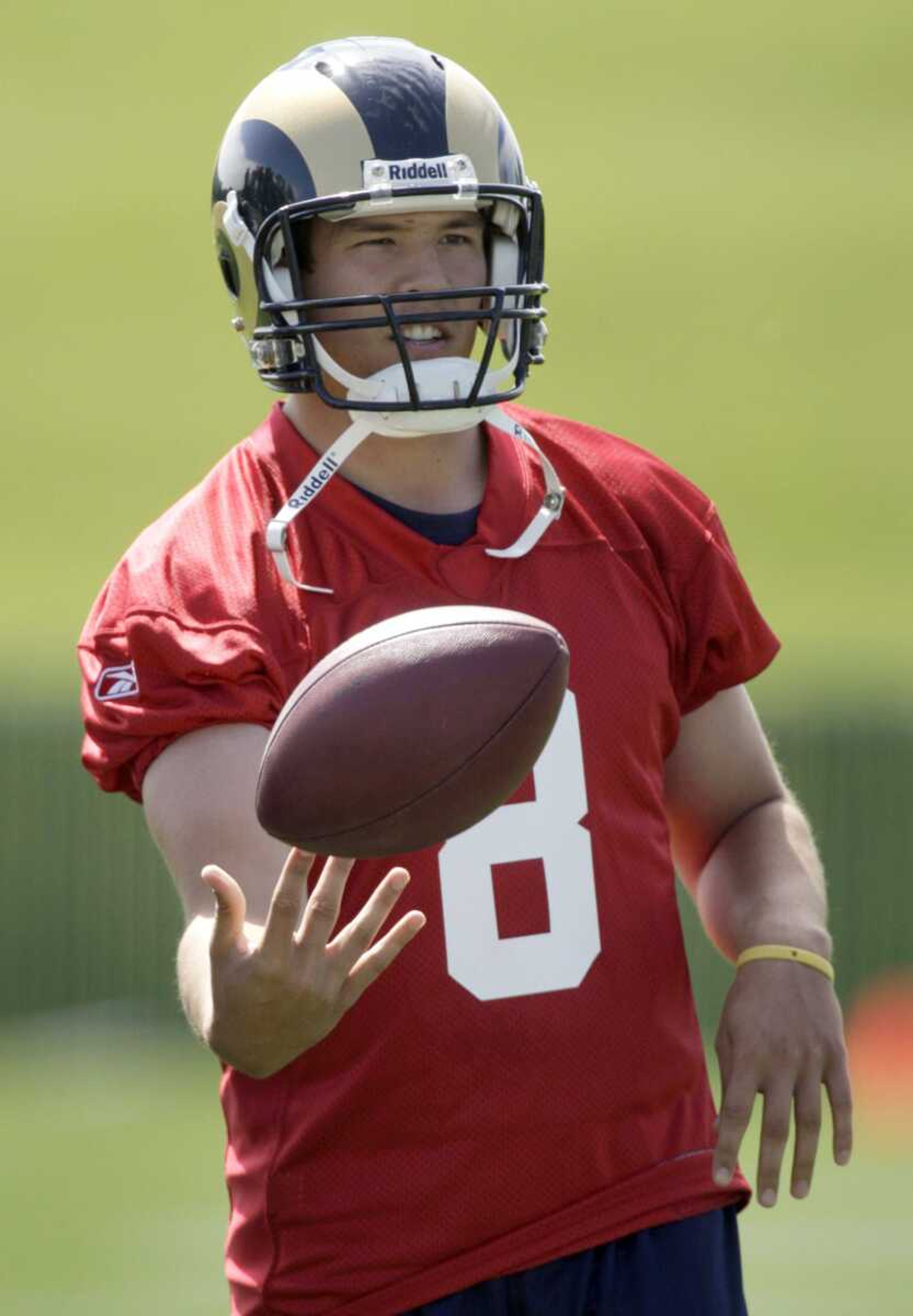 Rams quarterback Sam Bradford tosses a ball during a May practice at the team's training facility in St. Louis. (Jeff Roberson ~ Associated Press)