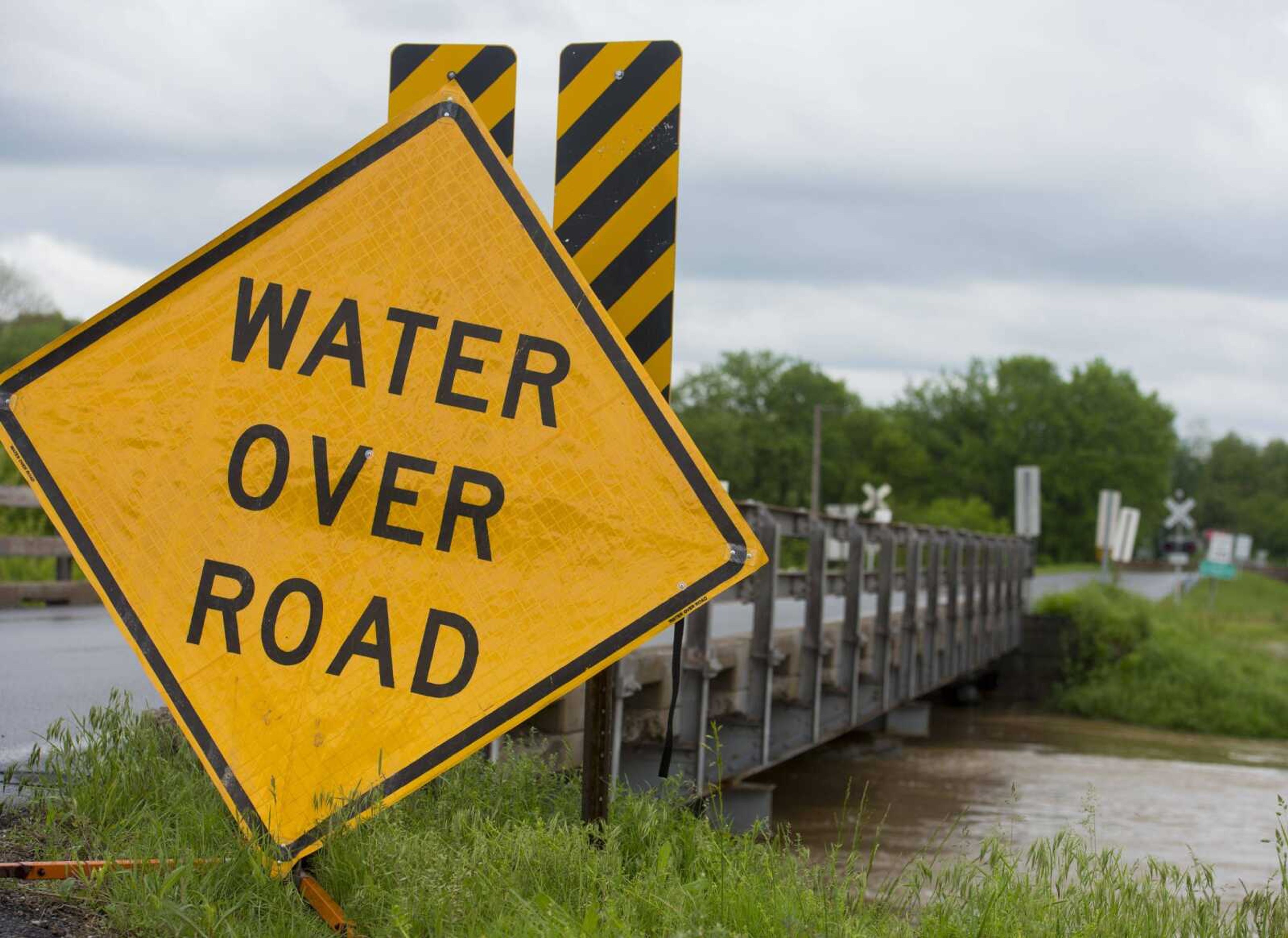 A hazard sign stands before a submerged section of Route Z on Sunday