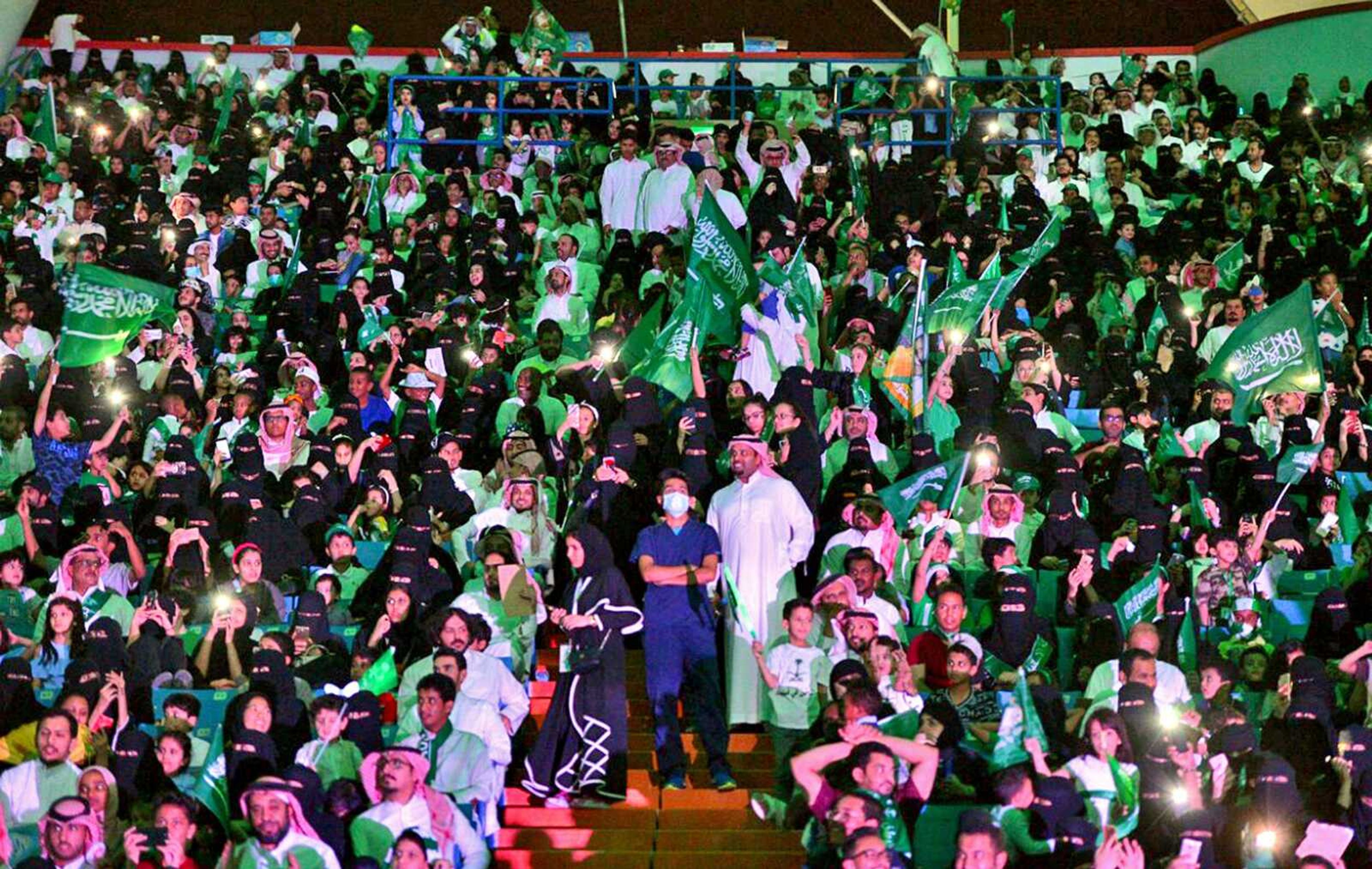 Saudi men and women attend national day ceremonies at the King Fahd stadium in Riyadh, Saudi Arabia, in this Sept. 23, 2017, photo.  On Friday, Saudi women were allowed to enter a sports stadium  to watch a soccer match for the first time.