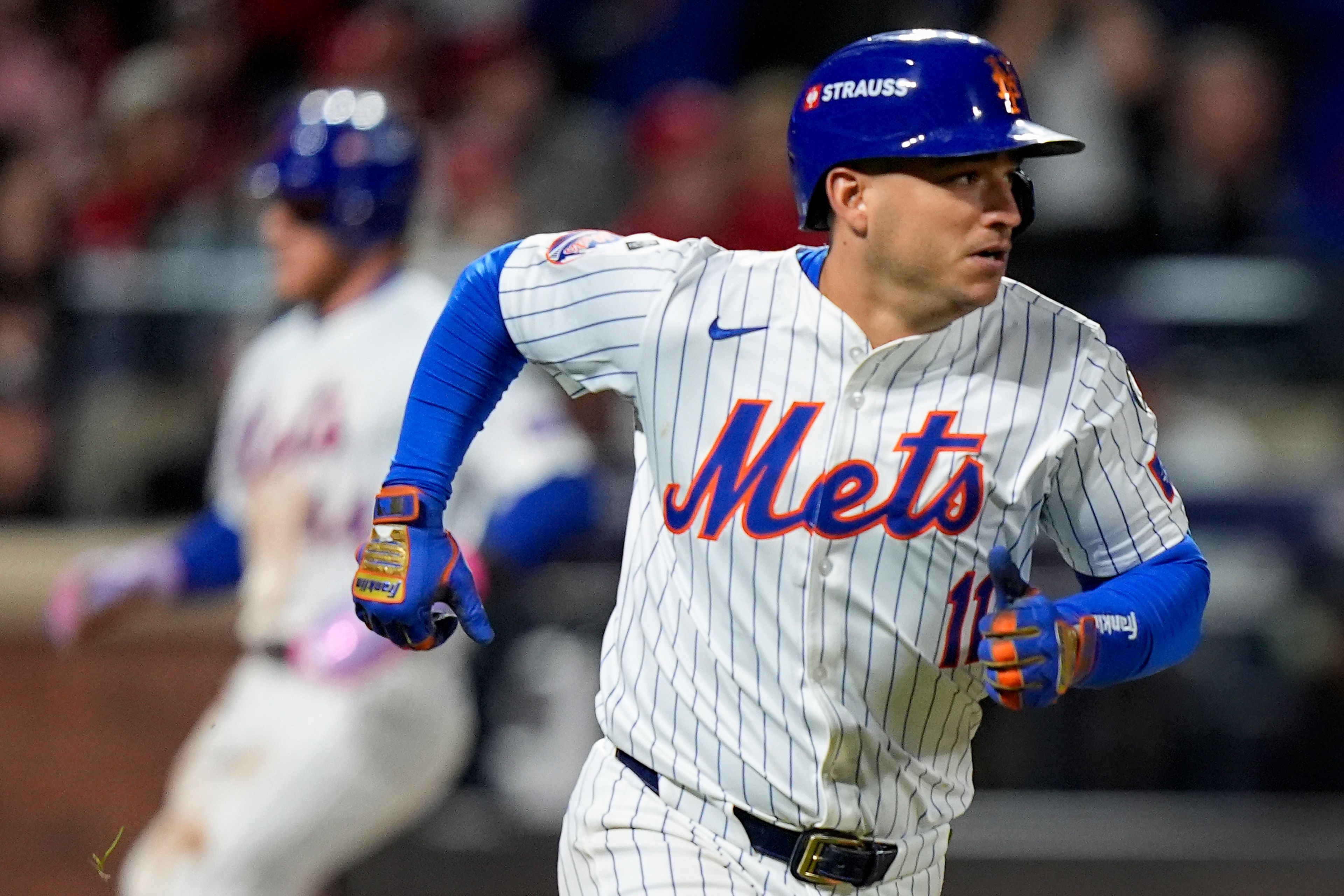 New York Mets' Jose Iglesias (11) heads for first after driving in two runs on a base hit against the Philadelphia Phillies during the seventh inning of Game 3 of the National League baseball playoff series, Tuesday, Oct. 8, 2024, in New York. (AP Photo/Frank Franklin II)