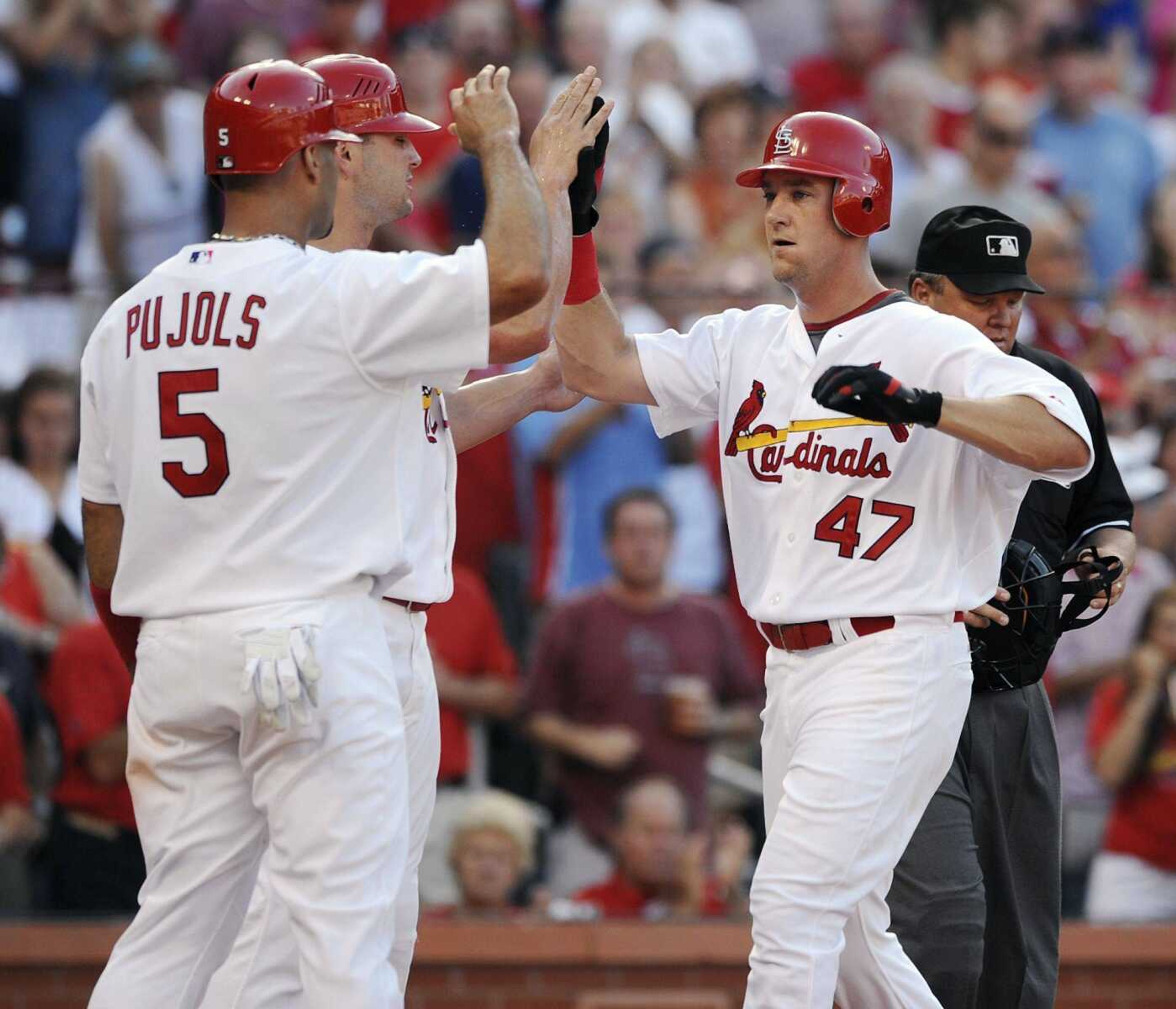 Cardinals outfielder Ryan Ludwick, right, is congratulated by teammates Albert Pujols and Matt Holliday after Ludwick's three-run home run during the first inning Monday in St. Louis. (BILL BOYCE ~ Associated Press)