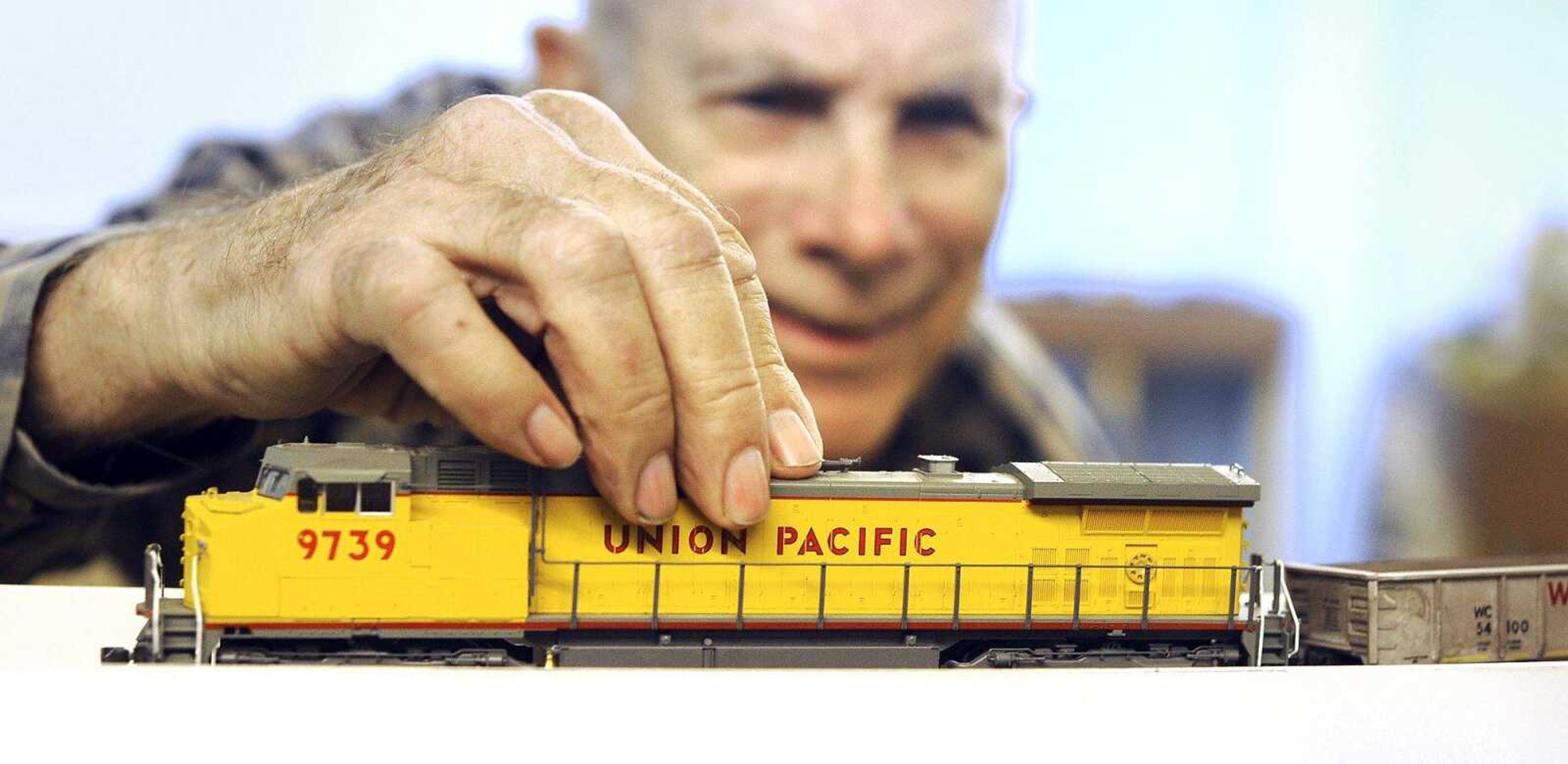 Dean Coffin adjusts the engine on his model train Tuesday in Cape Girardeau. (Laura Simon)