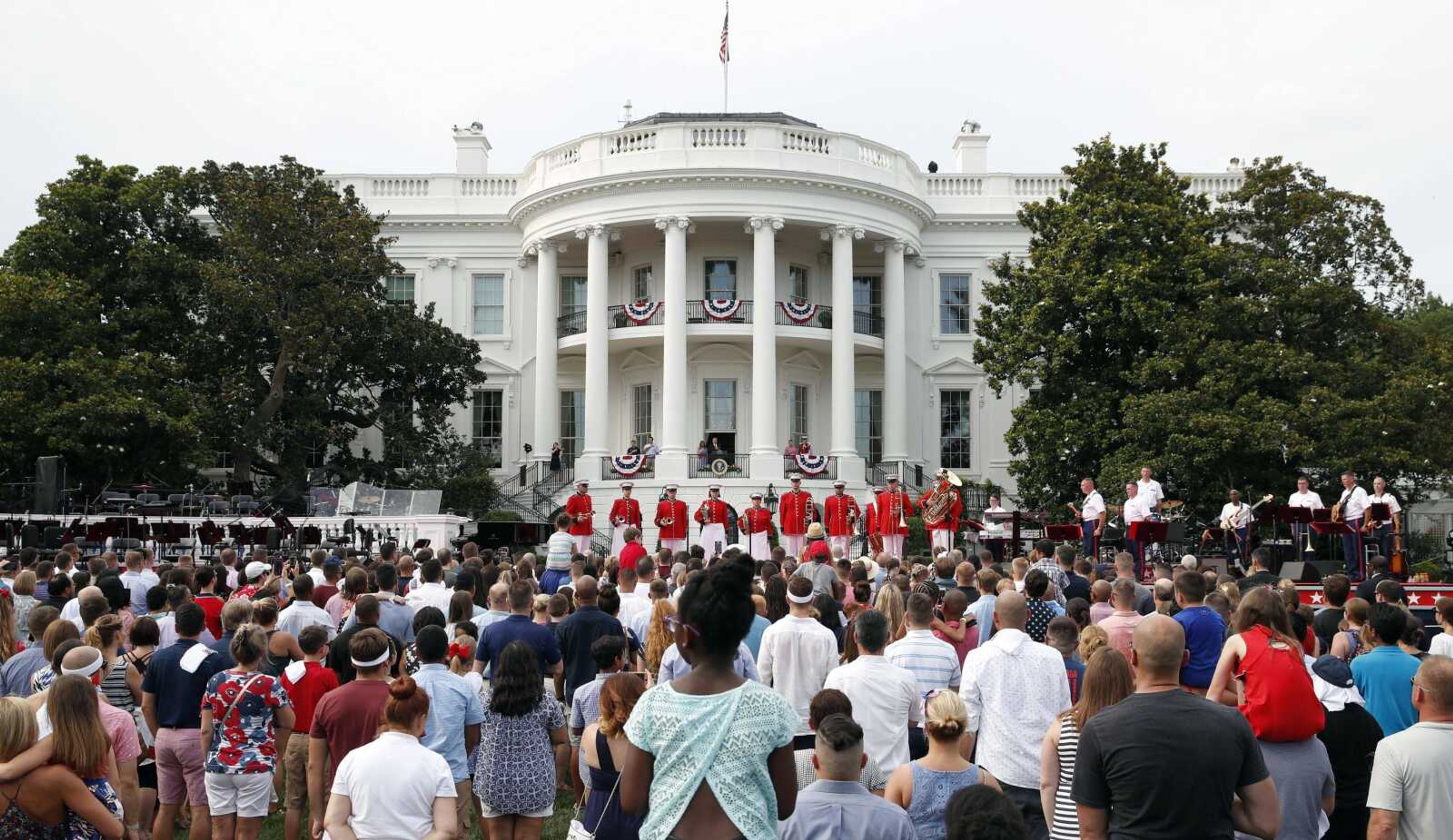 Crowds gathered at the White House listen to the playing of the national anthem during a Wednesday afternoon picnic for military families.