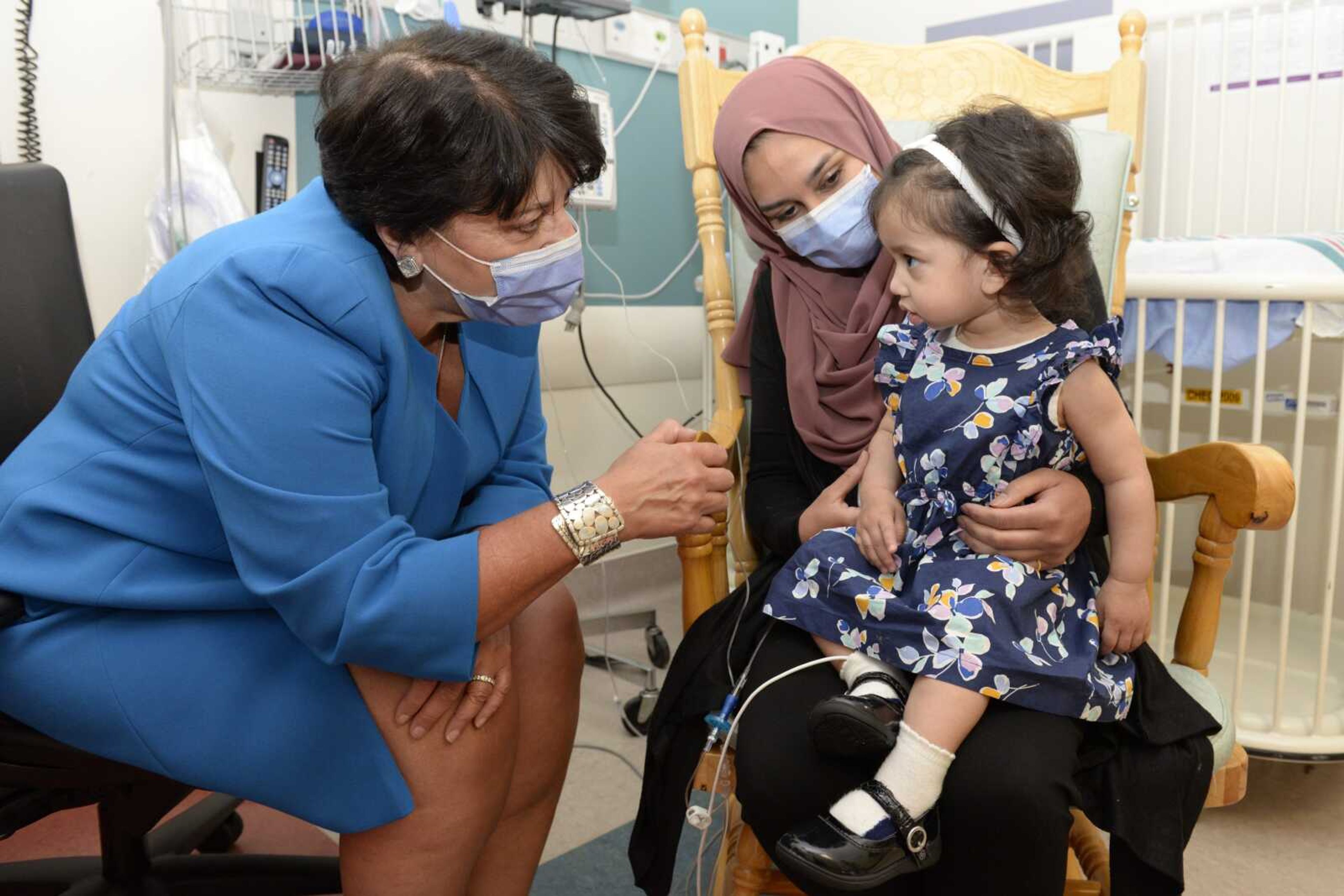 Ayla Bashir and her mother, Sobia Qureshi, meet with Dr. Karen Fung Kee Fung, right, of the Ottawa Hospital during an infusion day at the Children's Hospital of Eastern Ontario on Aug. 24.