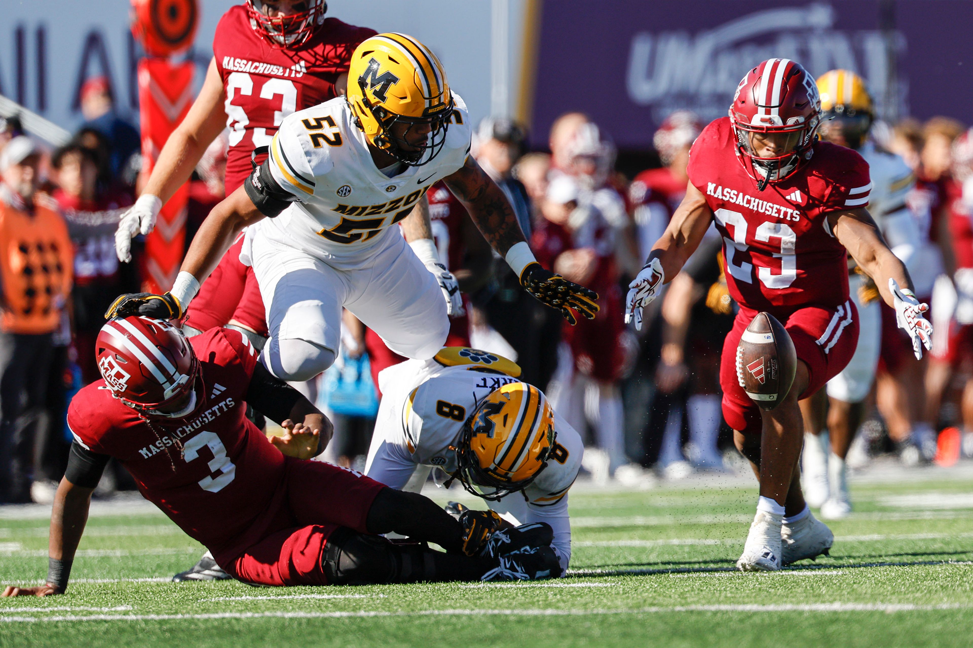 Massachusetts running back Brandon Campbell (23) recovers a fumble by quarterback Taisun Phommachanh (3) during the second half of an NCAA football game against Missouri on Saturday, Oct. 12, 2024, in Amherst, Mass. (AP Photo/Greg M. Cooper)