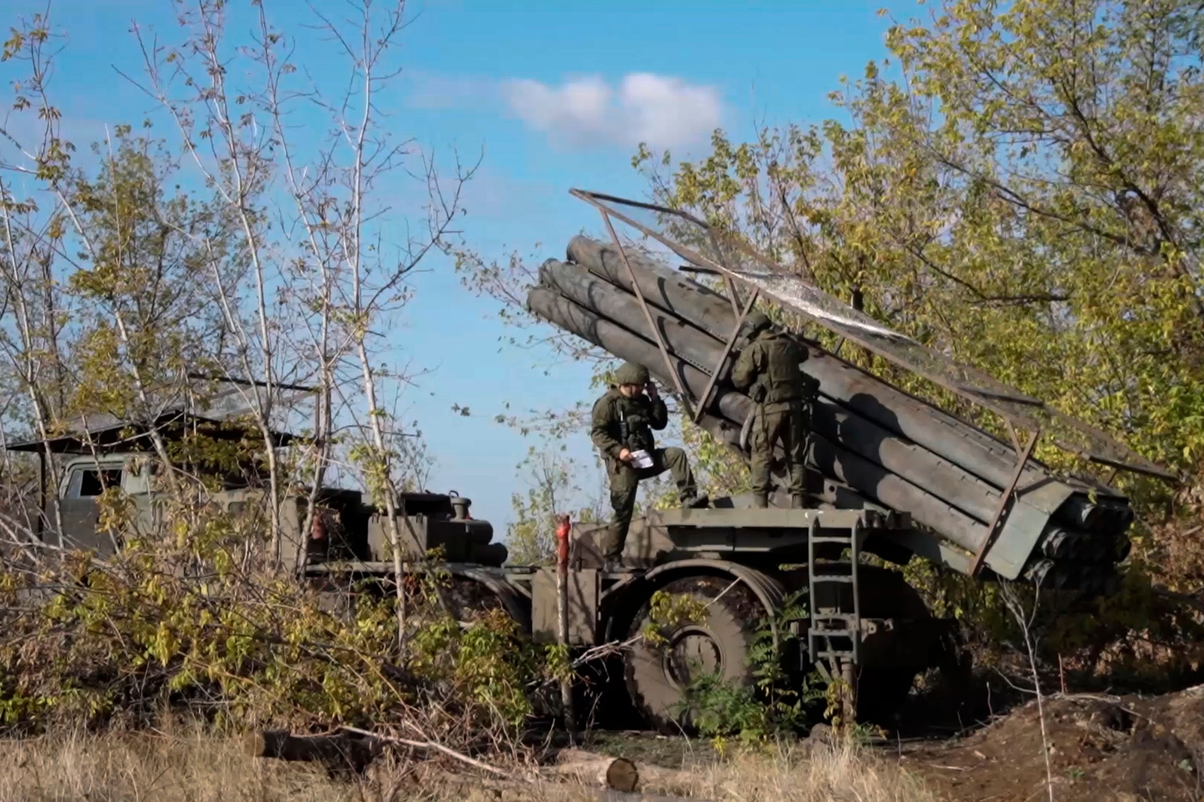 In this photo taken from a video released by Russian Defense Ministry press service on Monday, Nov. 25, 2024, Russian servicemen operate a Russian Uragan self-propelled multiple rocket launcher in an undisclosed location. (Russian Defense Ministry Press Service via AP)