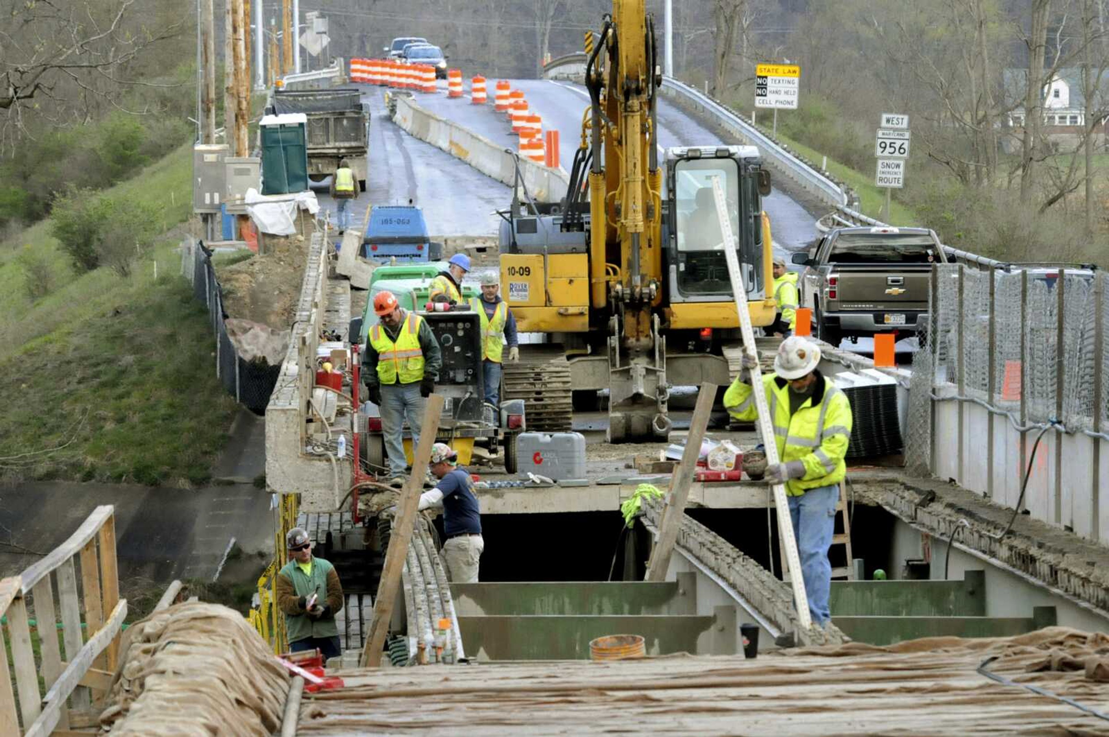 FILE - In this April 10, 2016, file photo, a construction crew with East Coast Bridge LLC, Nitro, West Virginia, works at the state Route 956 bridge over the Potomac River, commonly known as the ABL bridge, near Rawlings, Md.In the midst of an election year, President Donald Trump has outlined a new $1 trillion infrastructure plan. This time, the Republican president is proposing to rely fully on federal spending to reach his goal, a fundamental change that is praised by some state transportation officials and industry groups, even though Trump's proposal doesn t spell out how to pay for it all. (Steven Bittner/Cumberland Times-News via AP, File)