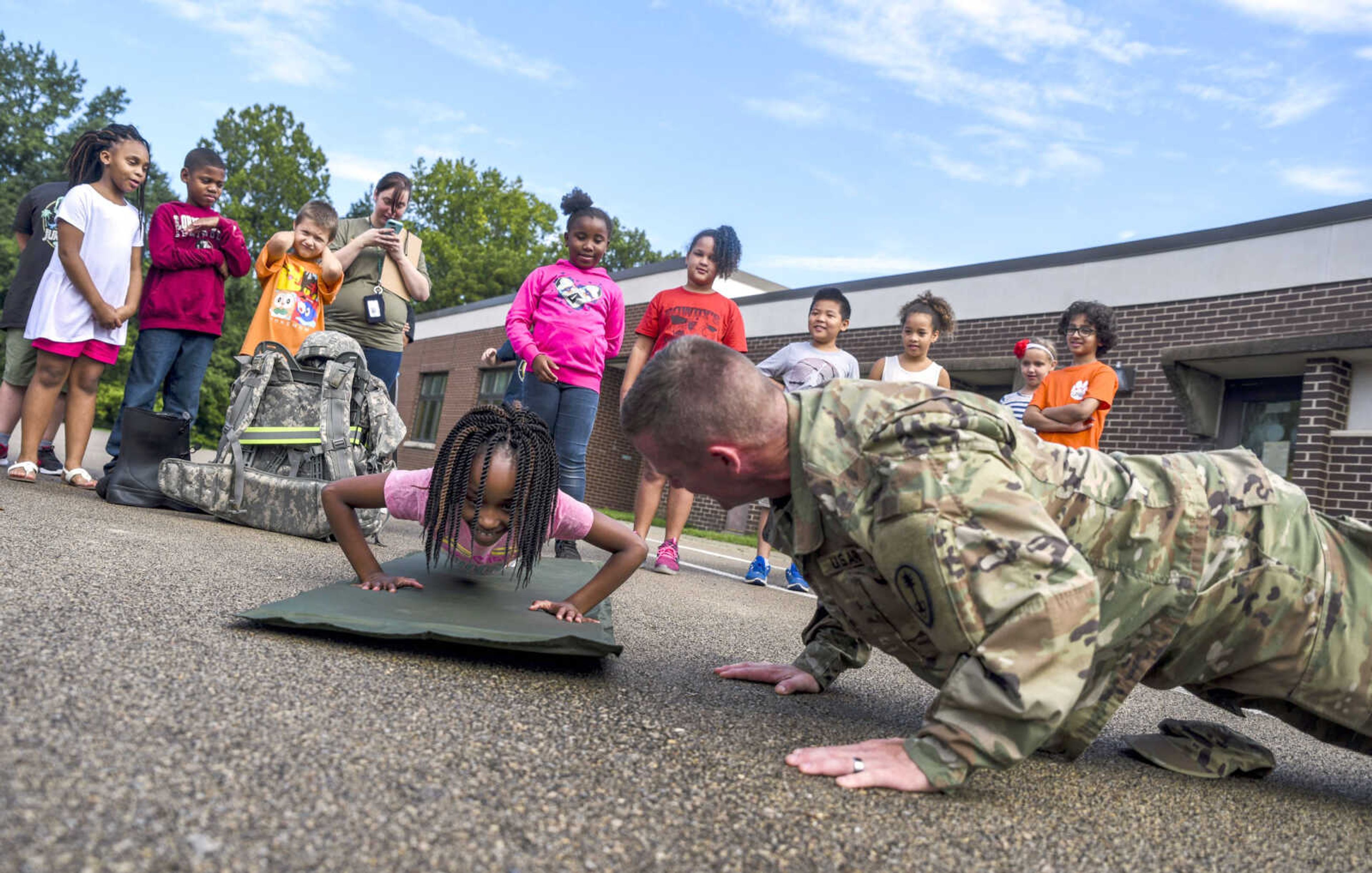 Sgt. Joey Beard, right, does pushups with third-grader Jiaiyla Harris on Friday during Clippard Bootcamp at Clippard Elementary in Cape Girardeau.