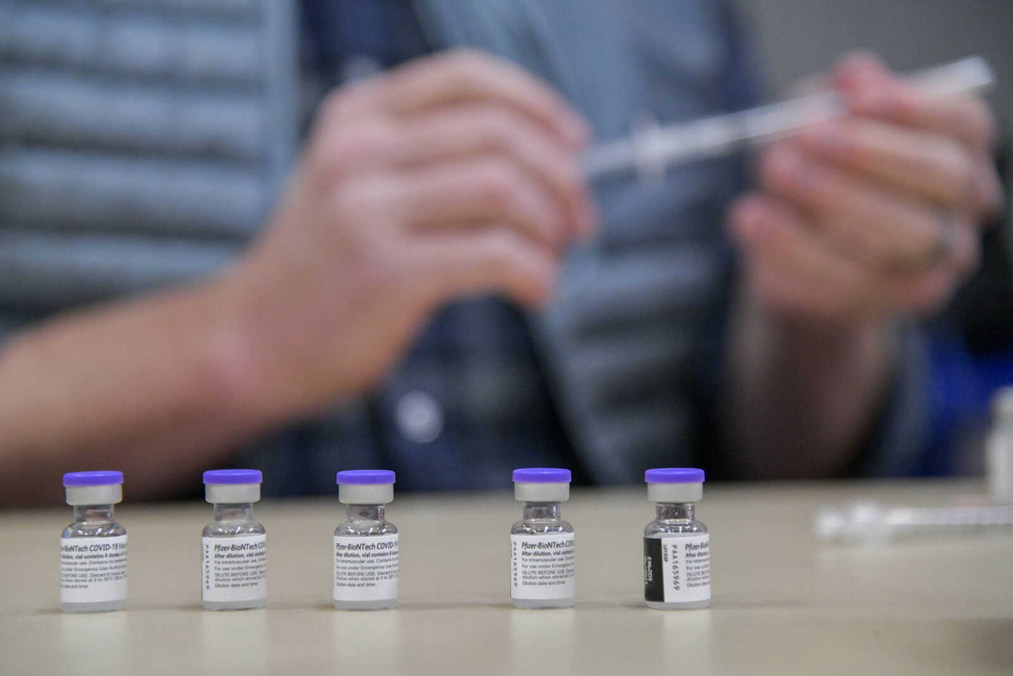 Pfizer-BioTech vaccine viles sit on a table before being put into syringes during a Broadway Pharmacy vacation clinic at the Show Me Center in Cape Girardeau on Thursday, March 4, 2021. 