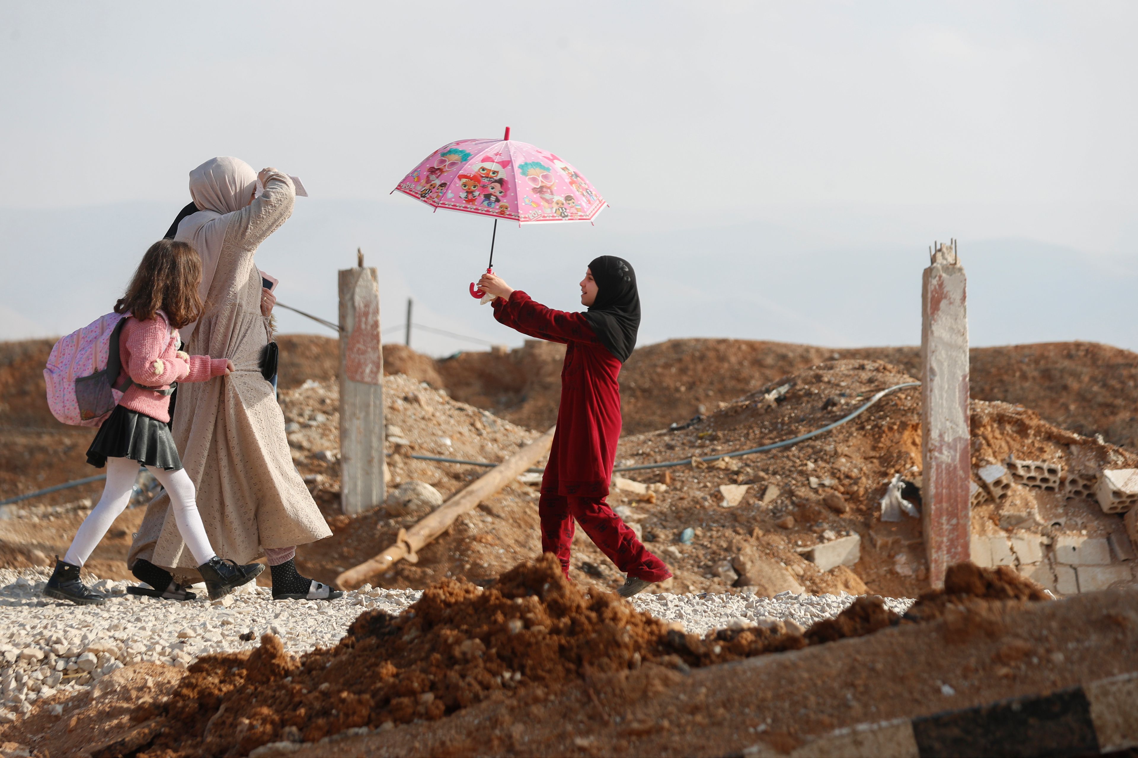 A family arrive to cross into Lebanon through the Jousieh border crossing, between Syria and Lebanon, Nov. 28, 2024, following a ceasefire between Israel and Hezbollah that went into effect on Wednesday. (AP Photo/Omar Sanadiki)