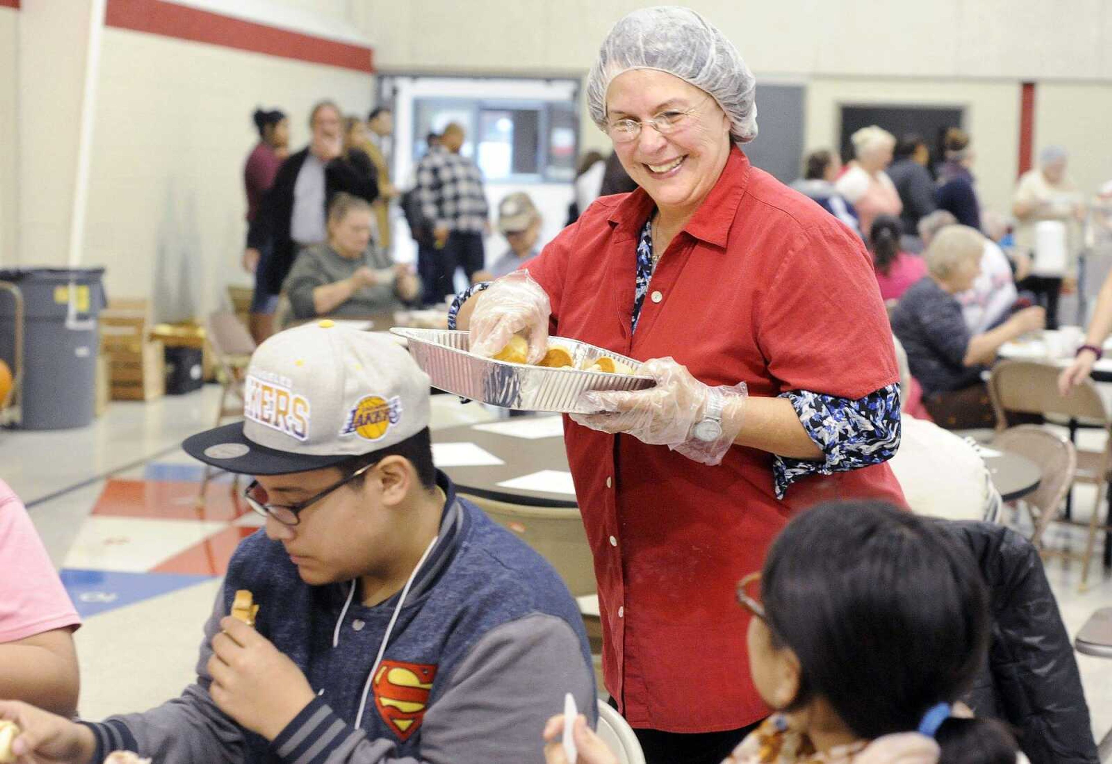 Barbara Norton passes out rolls Thursday during Thanksgiving lunch at the Salvation Army in Cape Girardeau. (Laura Simon)