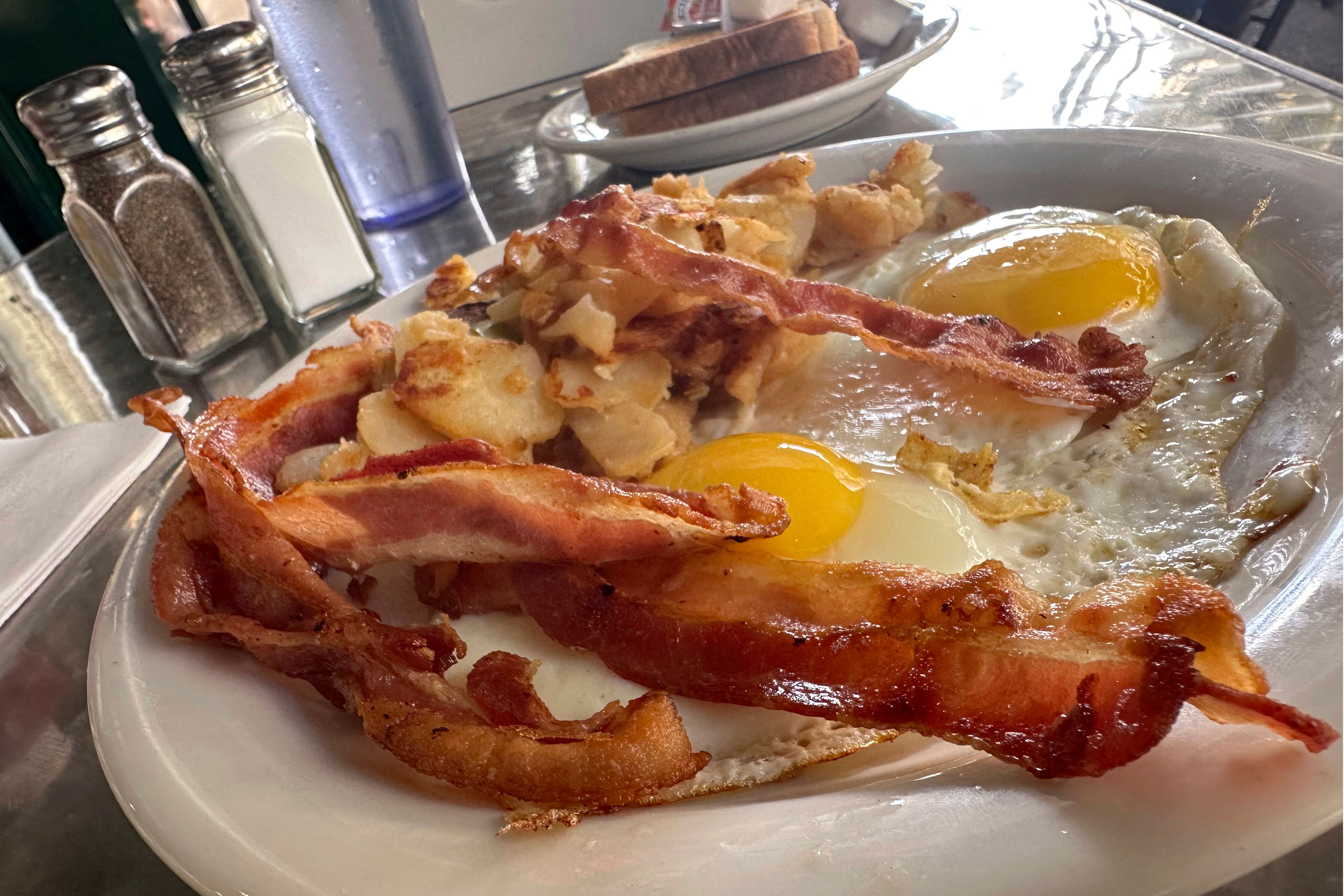 A plate with bacon and eggs is shown in New York, Monday, Oct. 7. 2024. (AP Photo/Richard Drew)