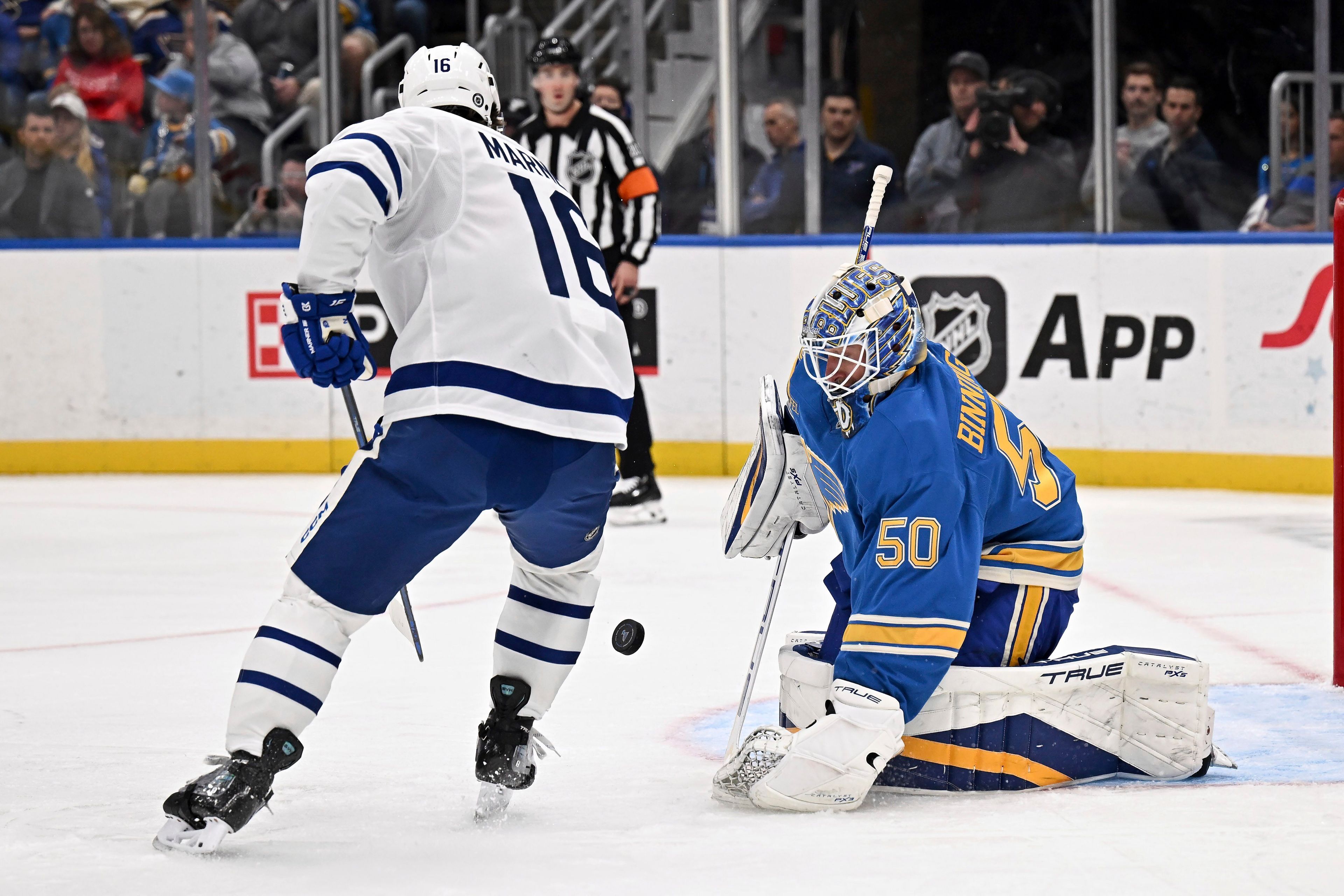 St. Louis Blues' goaltender Jordan Binnington (50) defends the net against Toronto Maple Leafs' Mitch Marner (15), left, during the first period of an NHL hockey game Saturday, Nov. 2, 2024, in St. Louis. (AP Photo/Connor Hamilton)