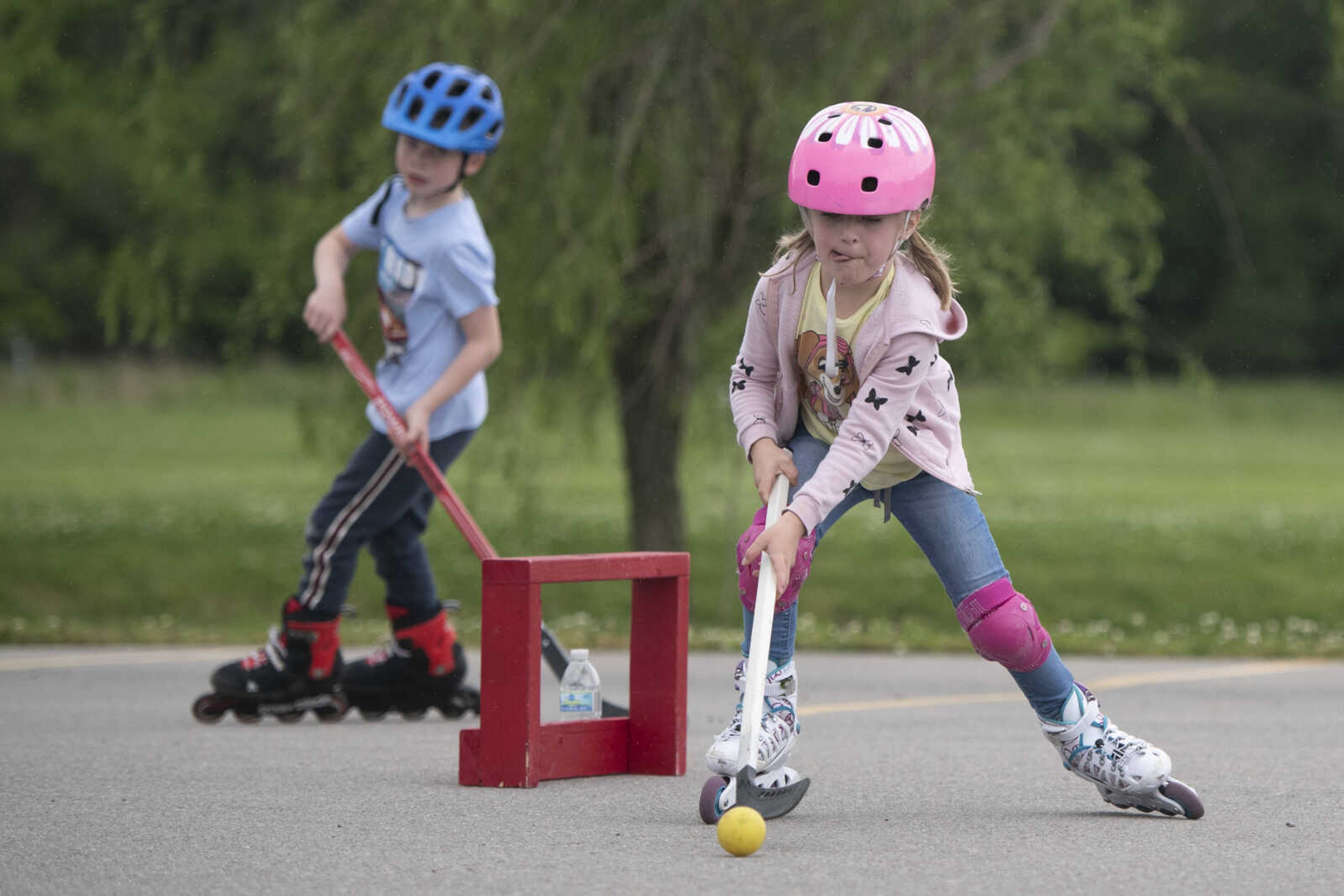 Matilda Booch, 5, handles a ball near her brother Henri Booch, 7, on Wednesday, May 20, 2020, at a parking lot near Cape Splash Family Aquatic Center in Cape Girardeau.