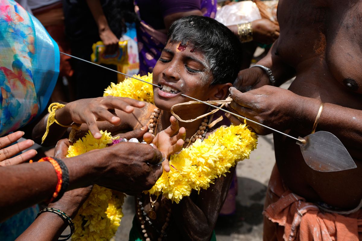 Hindu devotees honor goddesses in India and Britain, in phot...