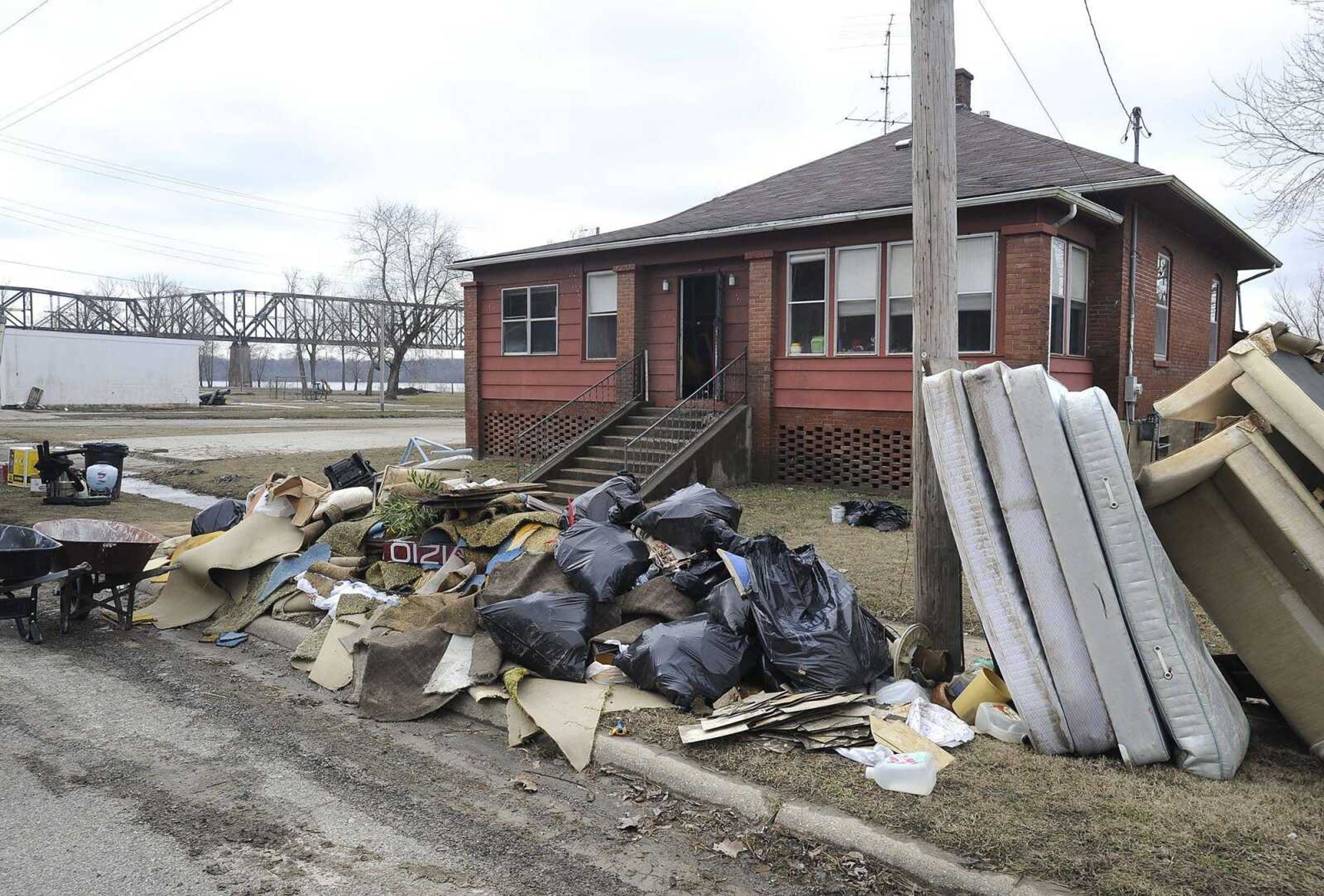 Flood-damaged items were being removed Saturday from a house in Thebes, Illinois. (Fred Lynch)