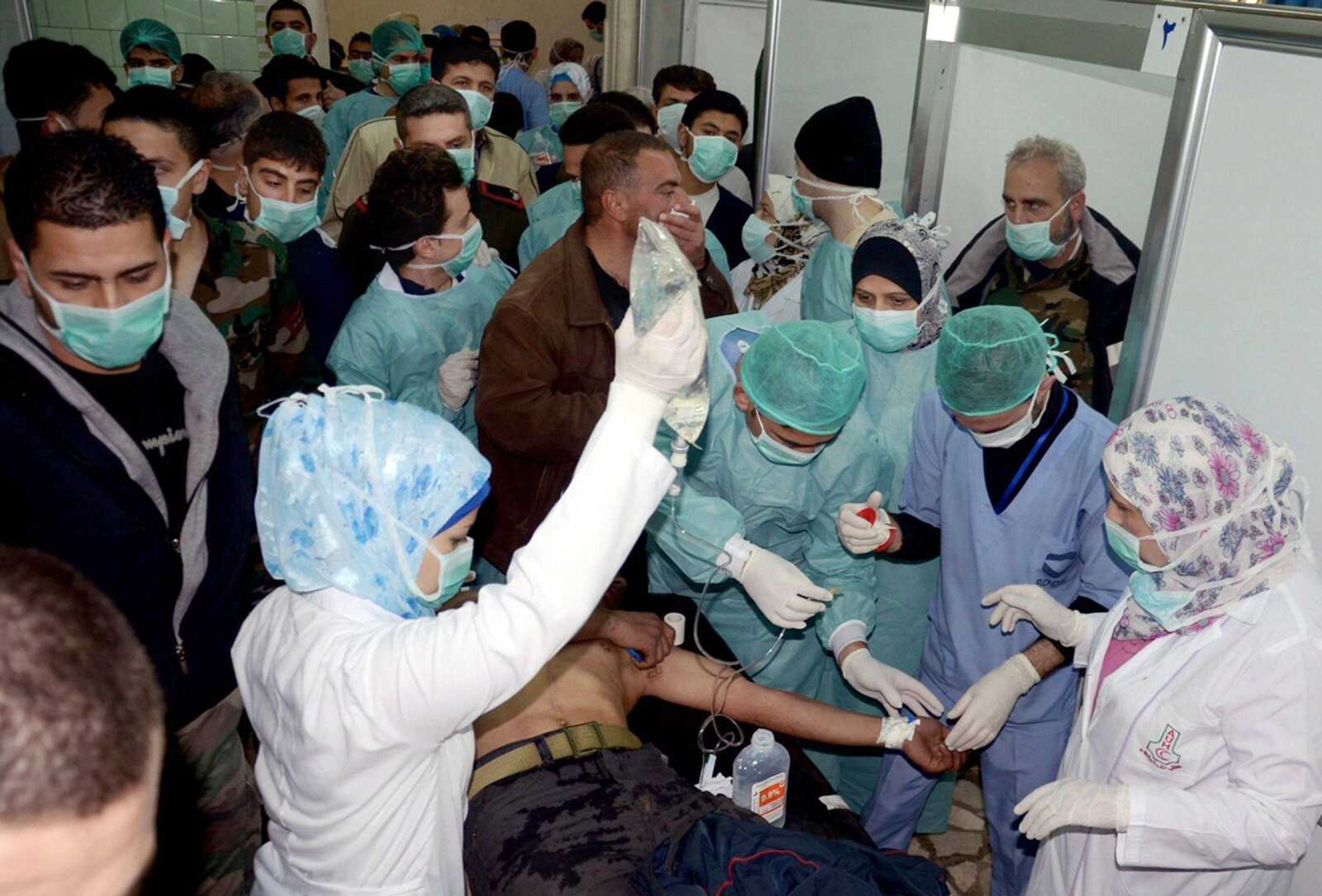 A Syrian victim, who suffered an alleged chemical attack at Khan al-Assal village according to official Syrian news agency SANA, receives treatment by doctors March 19 at a hospital in Aleppo, Syria. (SANA)